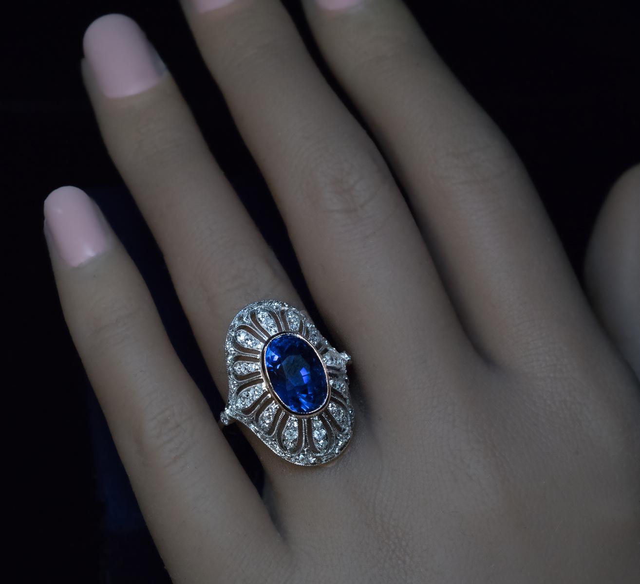 Made in Moscow in the 1930s.

This Art Deco era high dome openwork ring is finely crafted in platinum and gold. The ring is designed as a stylized oval flowerhead centered with a natural Ceylon sapphire of a vivid blue color. The sapphire has an