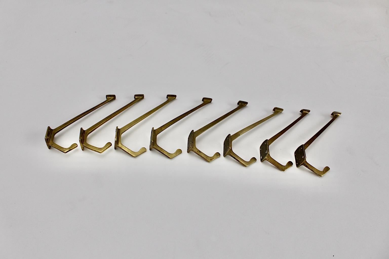 Art Deco vintage set of eight coat hooks from solid brass designed circa 1918 Vienna.
The set of eight coat hooks shows a well patinated brass surface in warm golden tone and are easily to fix each with 4 brass screws.
Approx. measures:
Depth 11