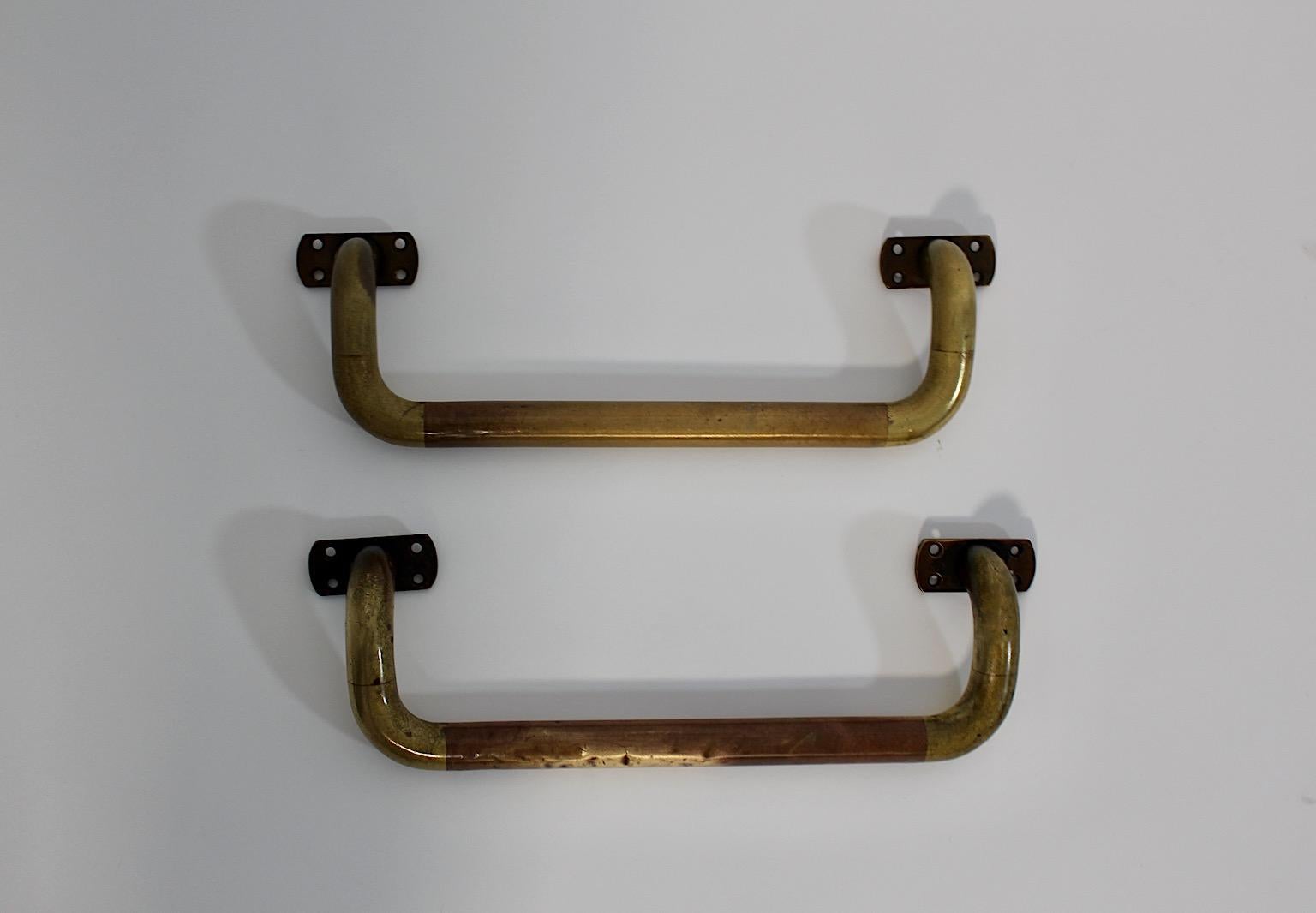 Art Deco vintage pair duo handles or towel racks or towel rails from solid brass Austria 1930s.
A wonderful pair or duo of handles from solid brass manufactured 1930s characterized through desirable patina features with simpleness and clear