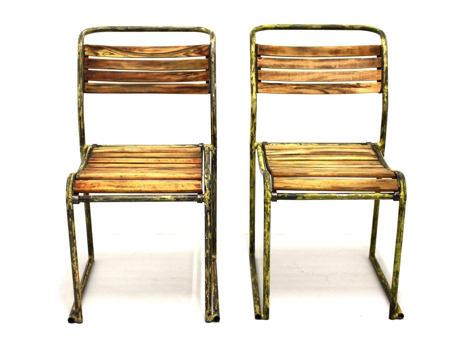 Art Deco vintage steel chairs model RP6 by Bruno Pollak 1931-1932 and manufactured by PEL Ltd. England.
The beechwood slats and the tubular steel from this rare pair of chairs show lovely rests from yellow enamel. 
Also they are carefully cleaned