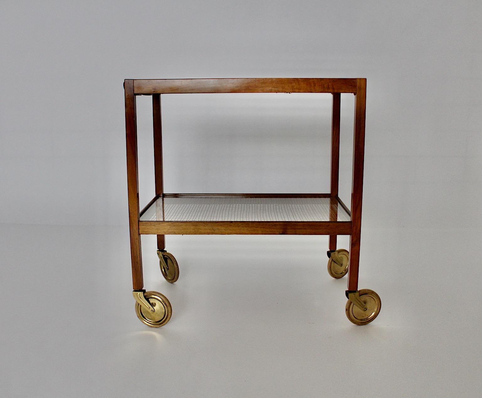 Art Deco vintage bar cart or serving table wheel supported from walnut and brass, the design is attributed to Julius Jirasek for Werkstätte Hagenauer circa 1935 Vienna.
A fabulous organic bar cart or serving table from walnut in stunning warm color