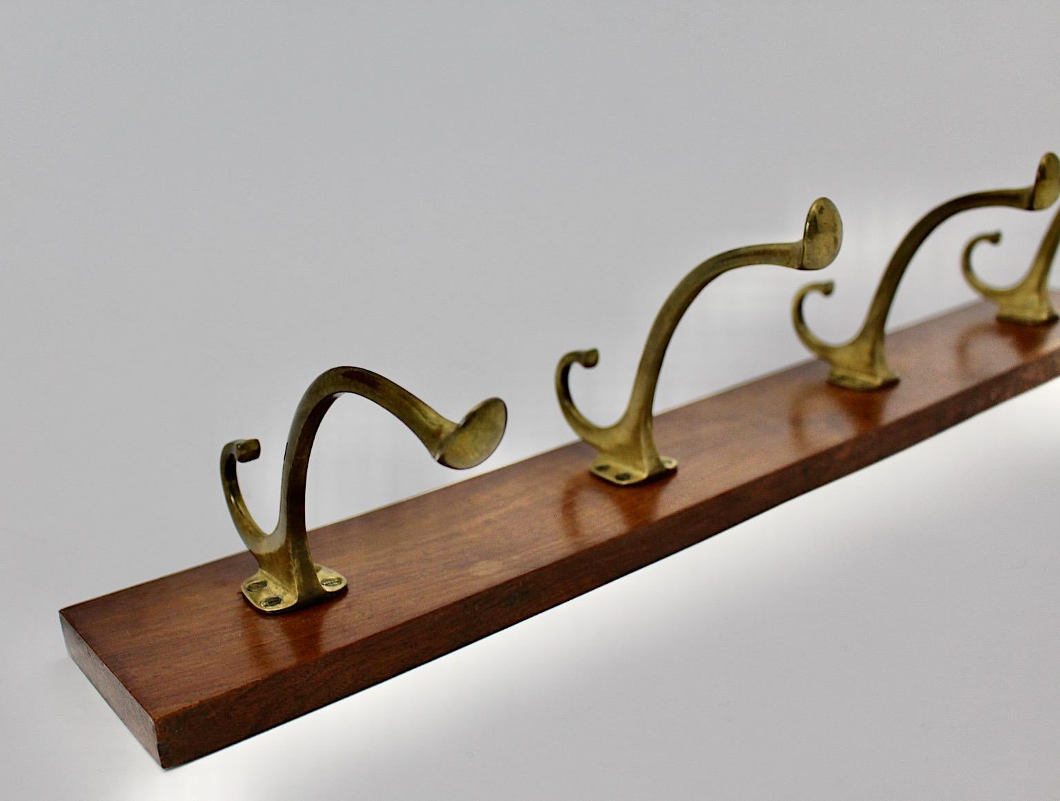Art Deco vintage coat rack from brass and walnut Style Adolf Loos 1930s Austria.
A wonderful classy coat rack with four brass coat hooks on a walnut board.
The rack is easy to fix with two screws.
While the walnut rack features a warm brown color
