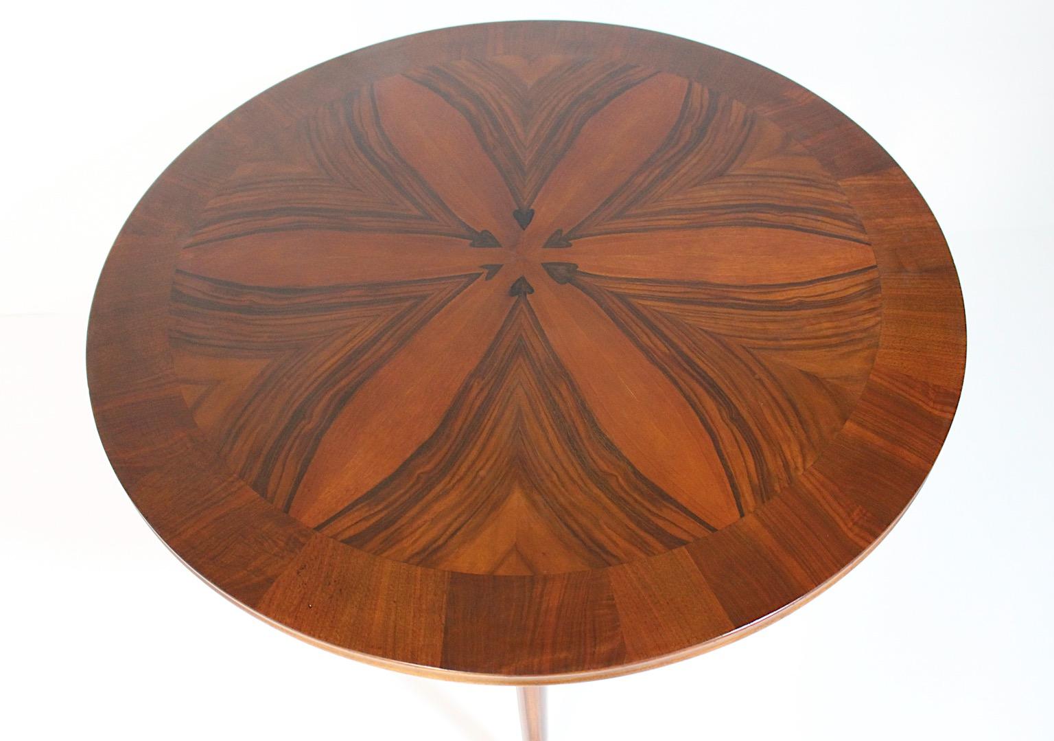 Art Deco vintage circular like coffee table or side table attributed to Josef Frank circa 1925 Vienna.
A beautiful coffee table with an extraordinary veneer pattern hearts like from walnut edged with a decor line.
With fluted legs and a wonderful