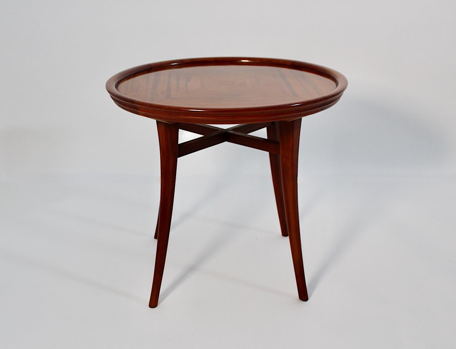 Art Deco vintage side table of sofa table from solid walnut and walnut veneer 1930s Vienna.
A stunning and high quality example from the range of Wiener Möbel 
made from walnut in circular shape and slightly curved feet.
The walnut veneered top