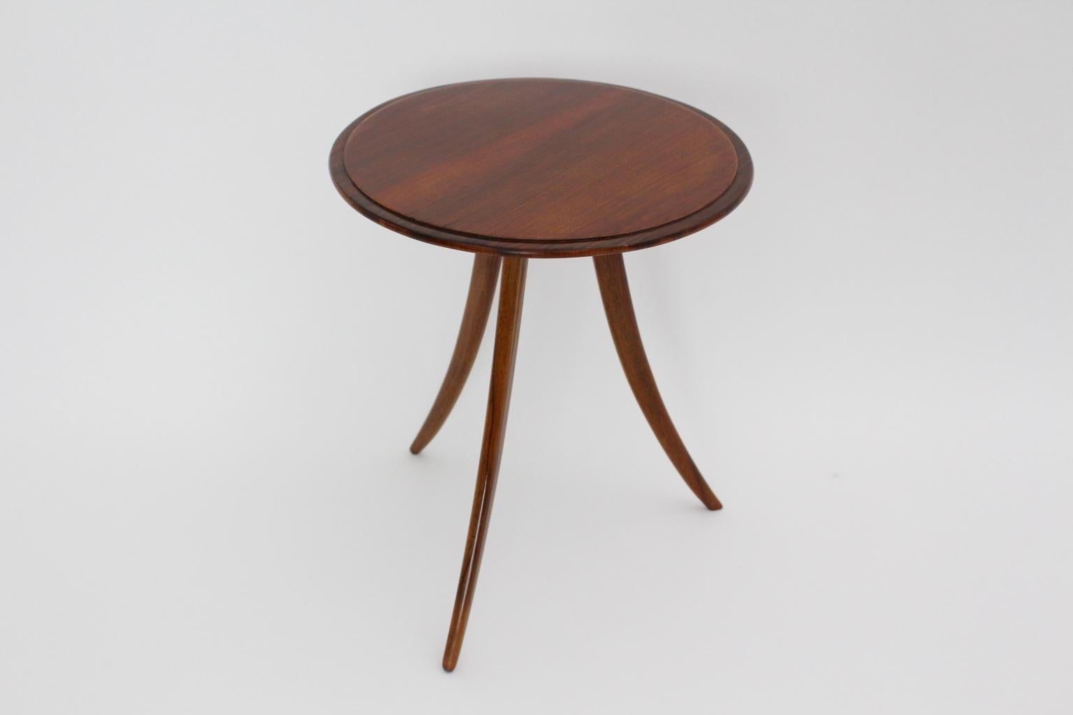 Art Deco circular coffee table or side table from walnut by Josef Frank for Haus & Garten circa 1925, Vienna.
The coffee table features three curved legs - solid walnut and a round walnut veneered tabletop.
So the coffee table stands for simple and
