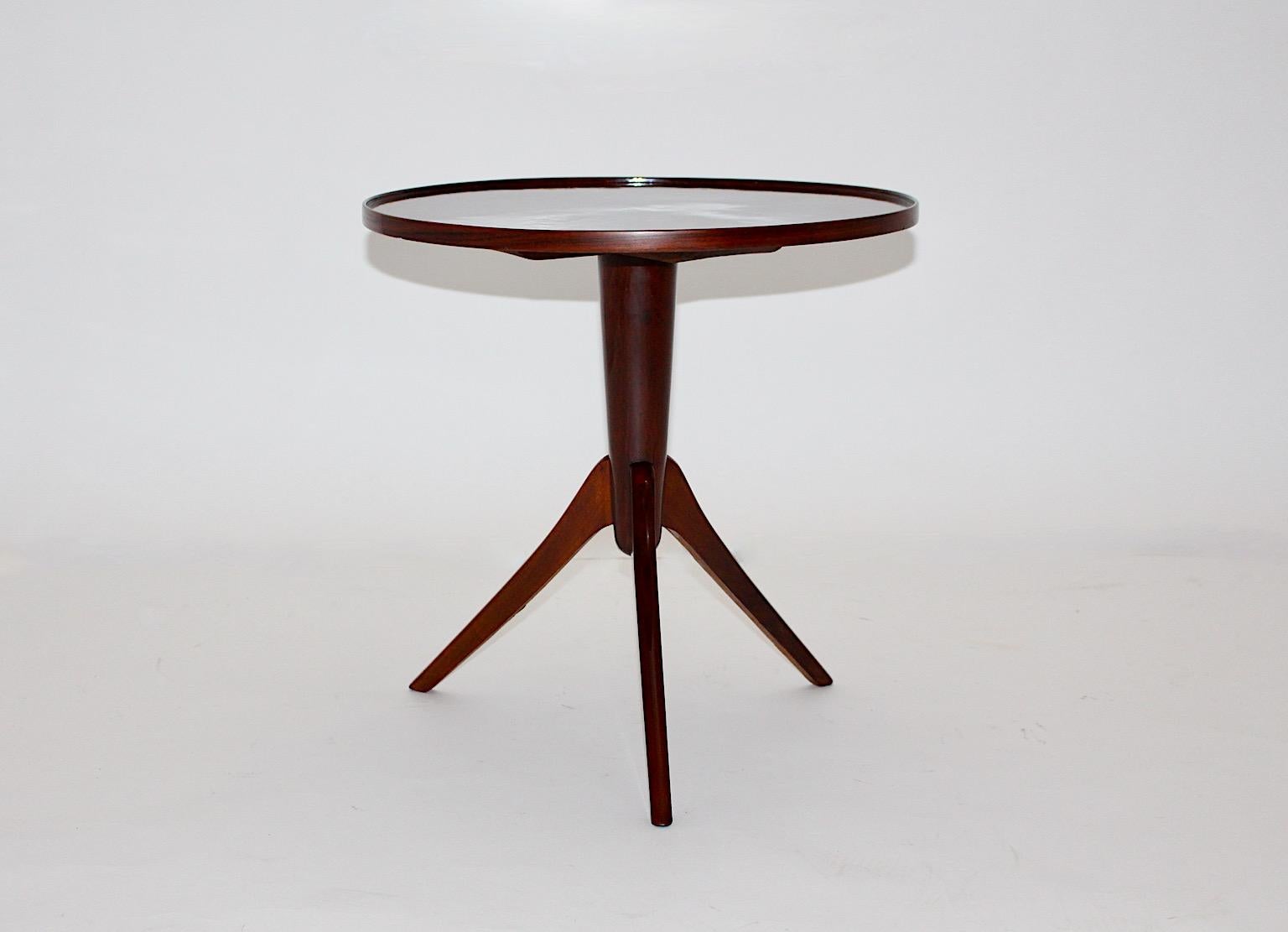 Art Deco vintage beautiful side table from walnut design attributed to Josef Frank 1930s Vienna.
The stellar shaped walnut veneers form an amazing veneer picture at the top, while the three legs made from solid walnut promise a good stability.
The