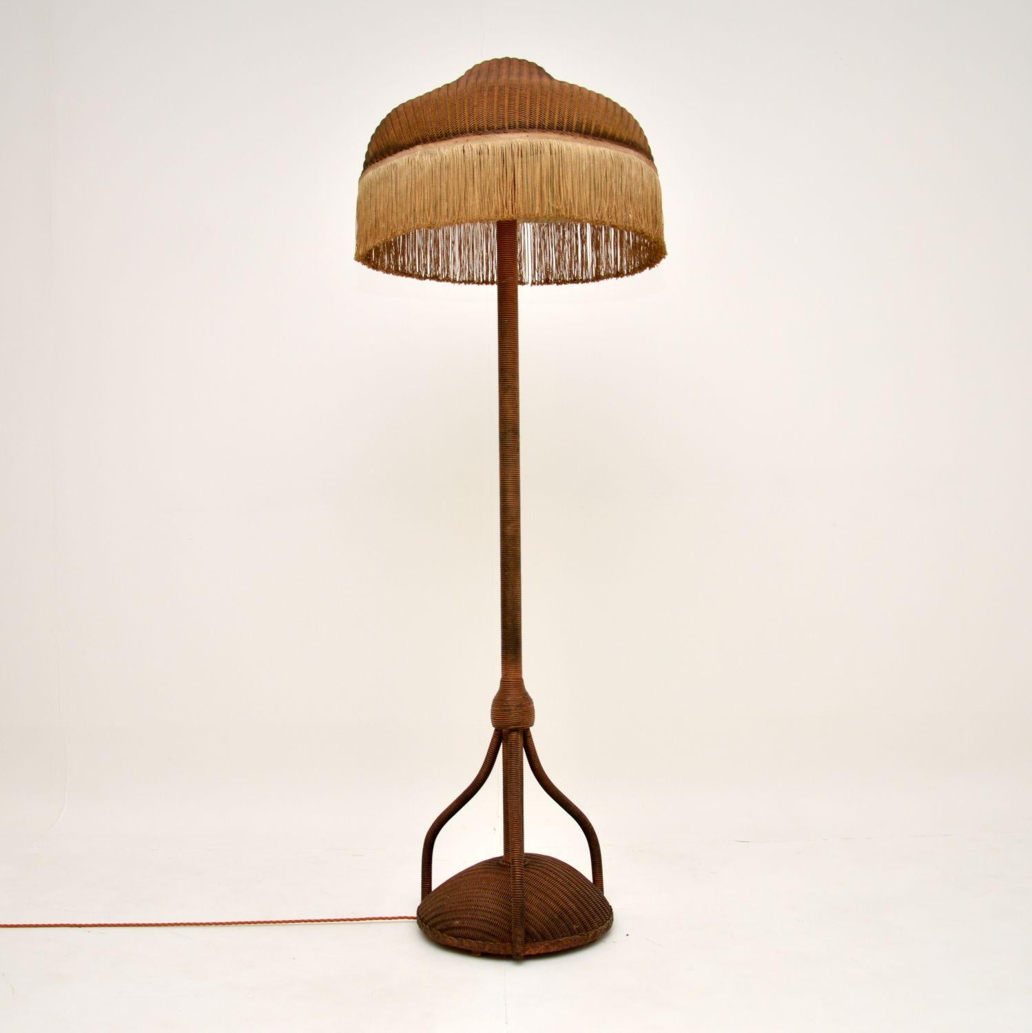 A beautiful and very rare floor lamp, completely made from woven wicker. This was made by Lloyd Loom in England, it has a date stamp underneath from 1937.

This unusual model is very well made and is in excellent condition for its age. We have