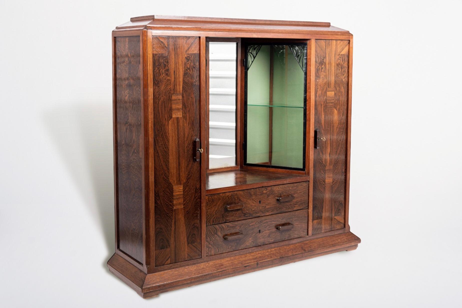 This exquisite French antique Art Deco wood and glass showcase or vitrine display cabinet by Ateliers Gauthier Poinsignon was made in Nancy, France circa 1920-1930. This exceptional cabinet displays the new, more geometric Art Deco style with strong