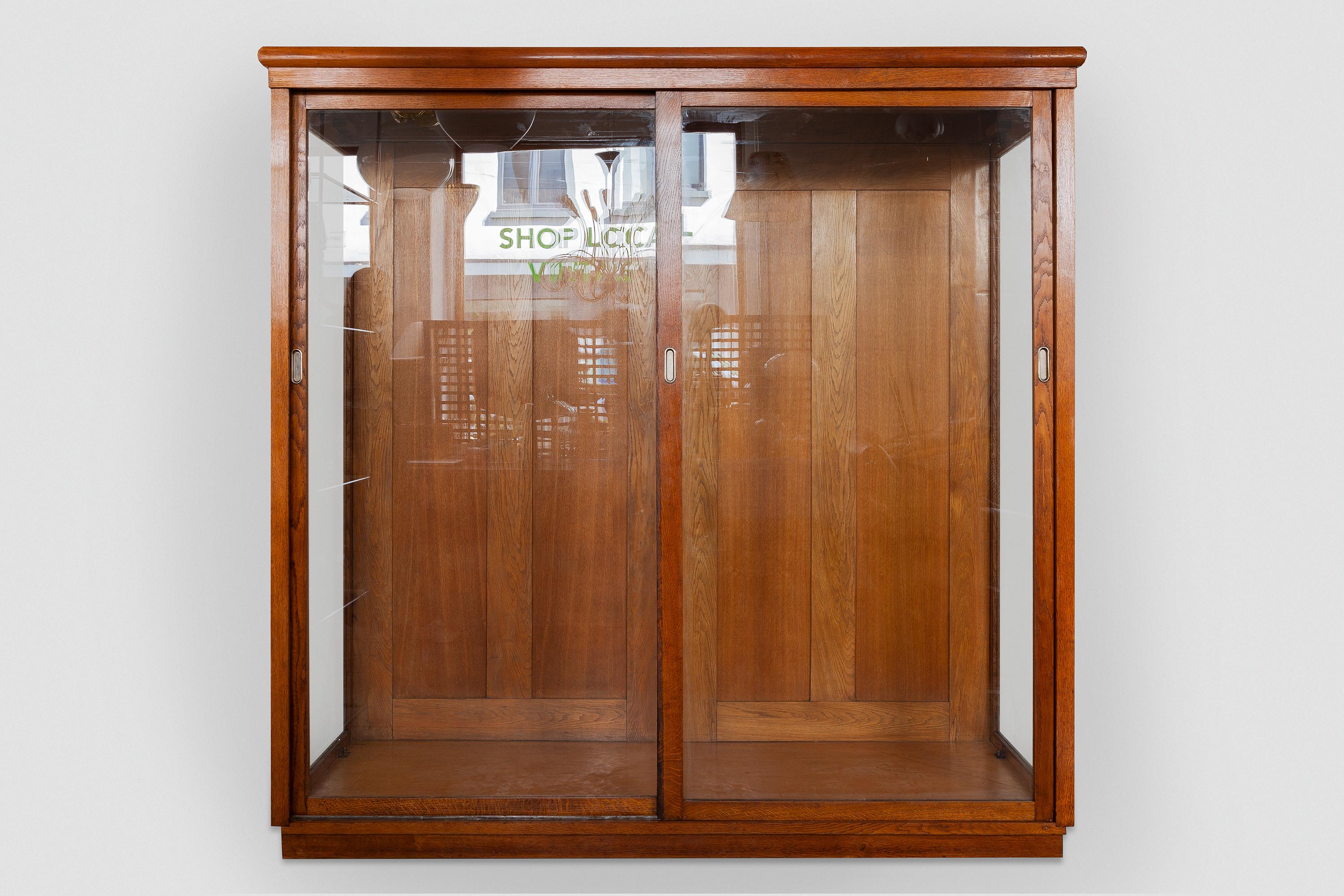 A beautiful Art Deco display cabinet from a former Haute Couture Dress store, suitable for hanging long dresses or coats also very effective for exhibiting your collection in a Wunderkammer setup or for presenting large objects. The furniture is