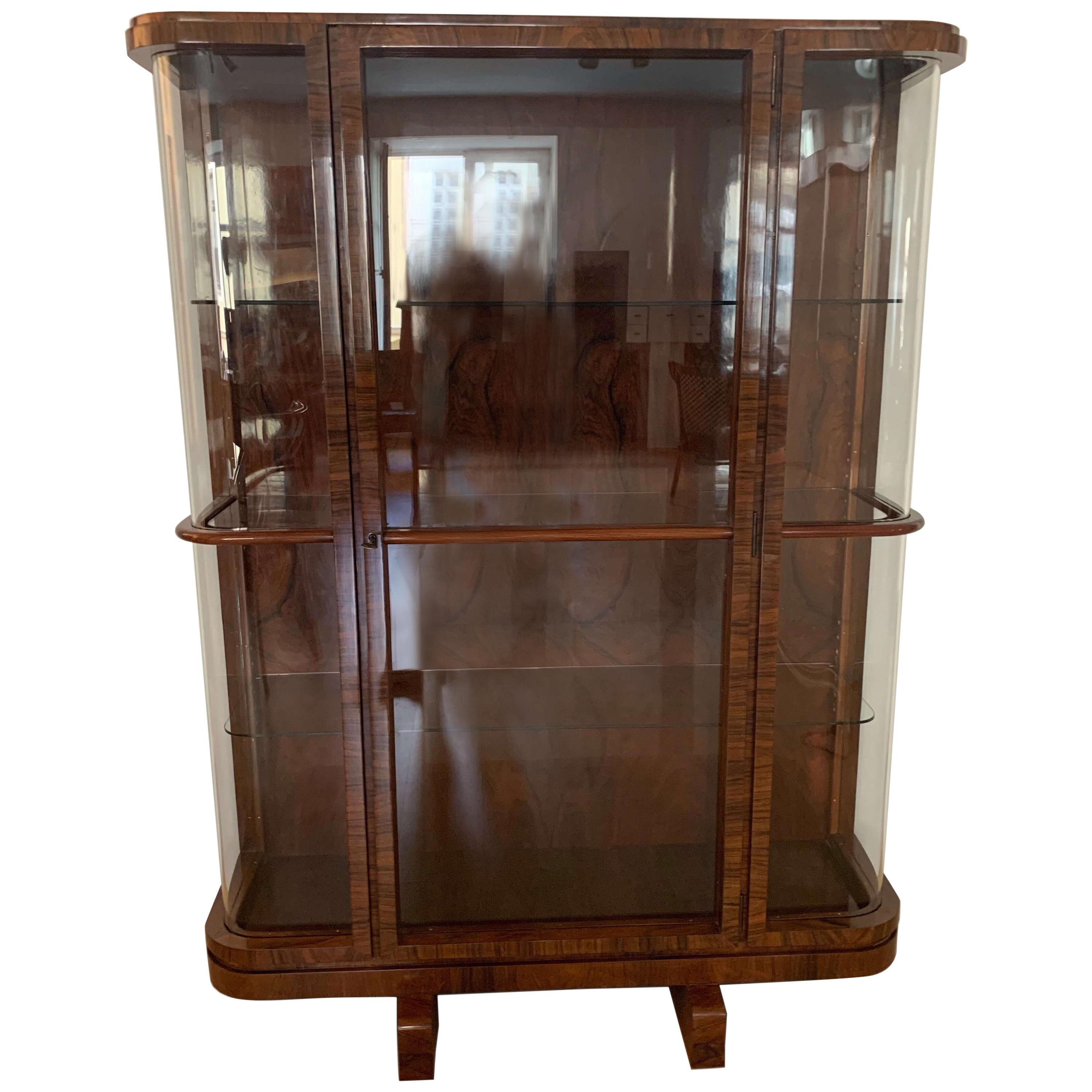 Wonderful original Art Deco vitrine or display case. 
Amazing rich rosewood / Palisander veneer, hand polished with shellac (French polish). 
Thick original curved glass windows and inlay shelves. Each of the three shelves can be adjusted in 7