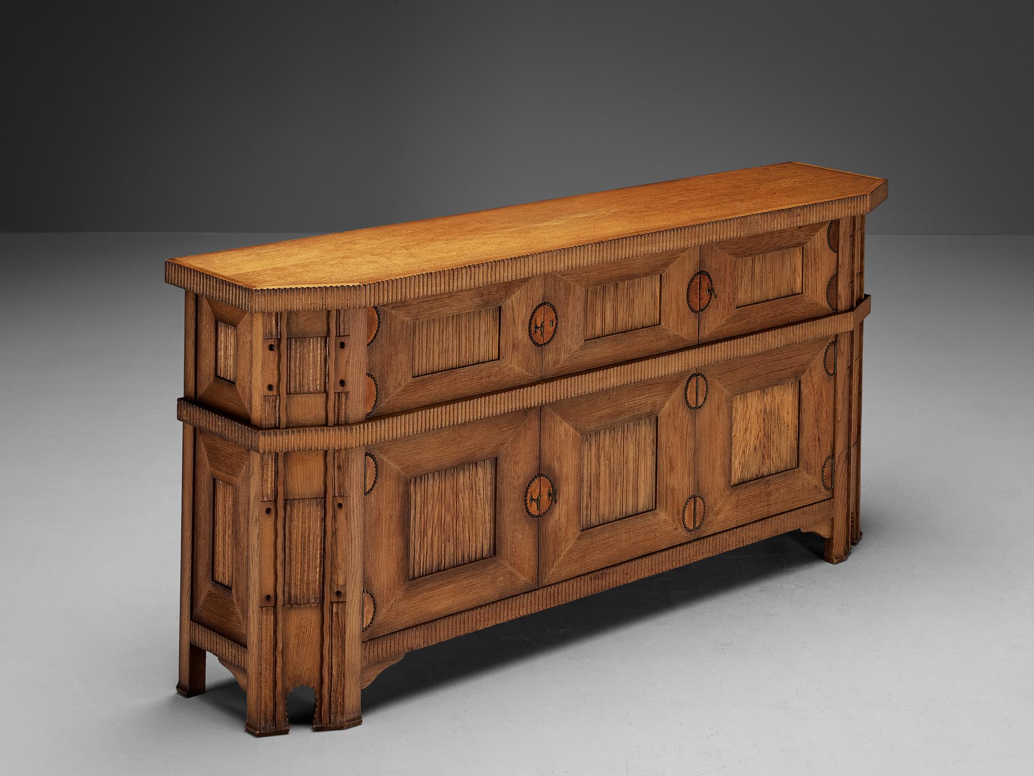Vittorio Valabrega, sideboard, oak, leather, brass, Italy, 1930s

This large Art Deco sideboard in oak by Vittorio Valabrega features not only visual qualities but also great storage space. Five doors are structuring the outside and are furnished