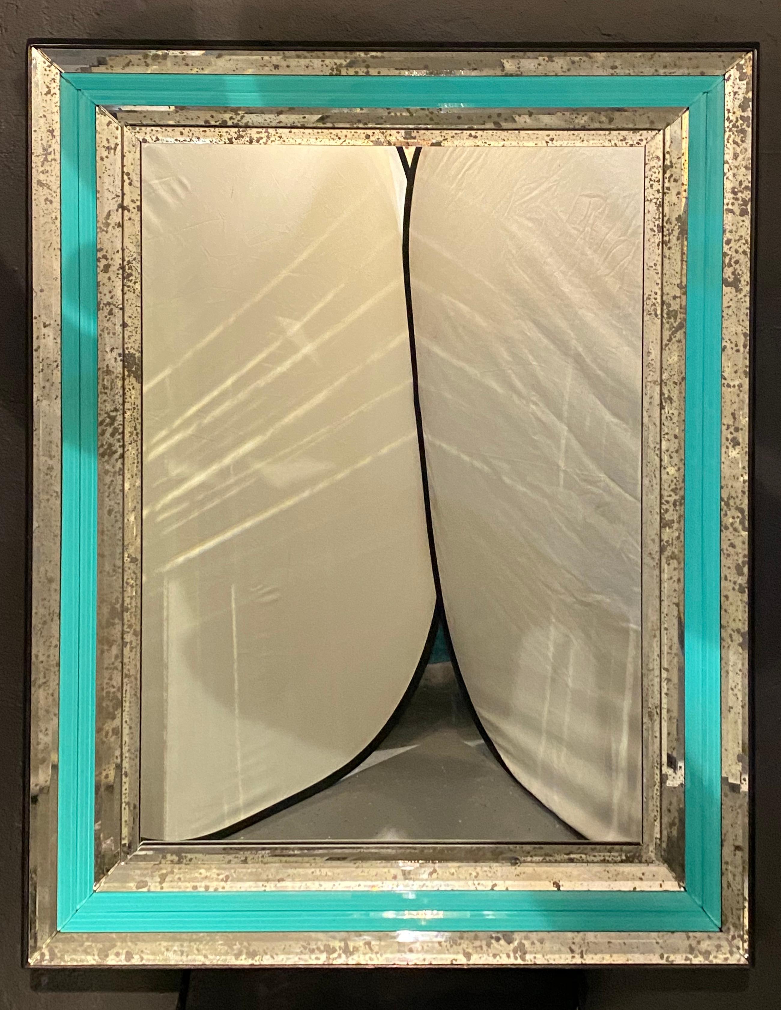 Art Deco wall, console or pier mirrors with turquoise beveled frames. A pair of large and impressive stunning monumental Art Deco style wall, console or pier mirrors with beveled frames. Each clear center mirror framed in a beveled antique mirror