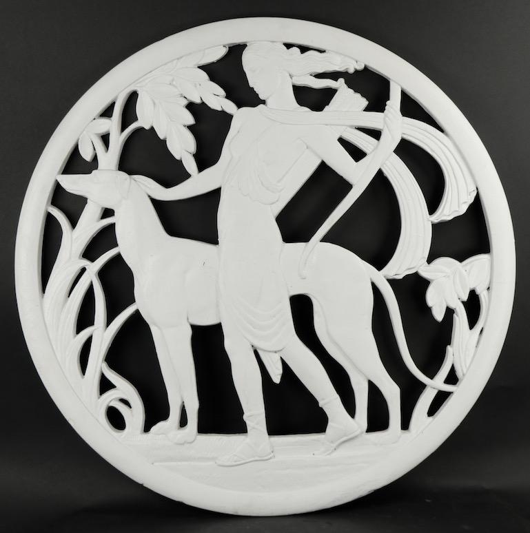 Dramatic plaster wall plaque depicting the mythological figure Diana the Huntress, and her dog. Signed and dated G.R. 1935, architectural American Art Deco item, which probably originally hung in a glamorous deco movie theater. This example is in