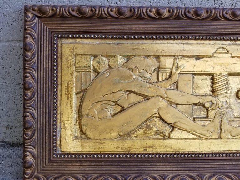 Classic 1920s Art Deco / Machine Age cast and gilt plaster wall plaque depicting 2 seated figures turning a mechanical screw press.
