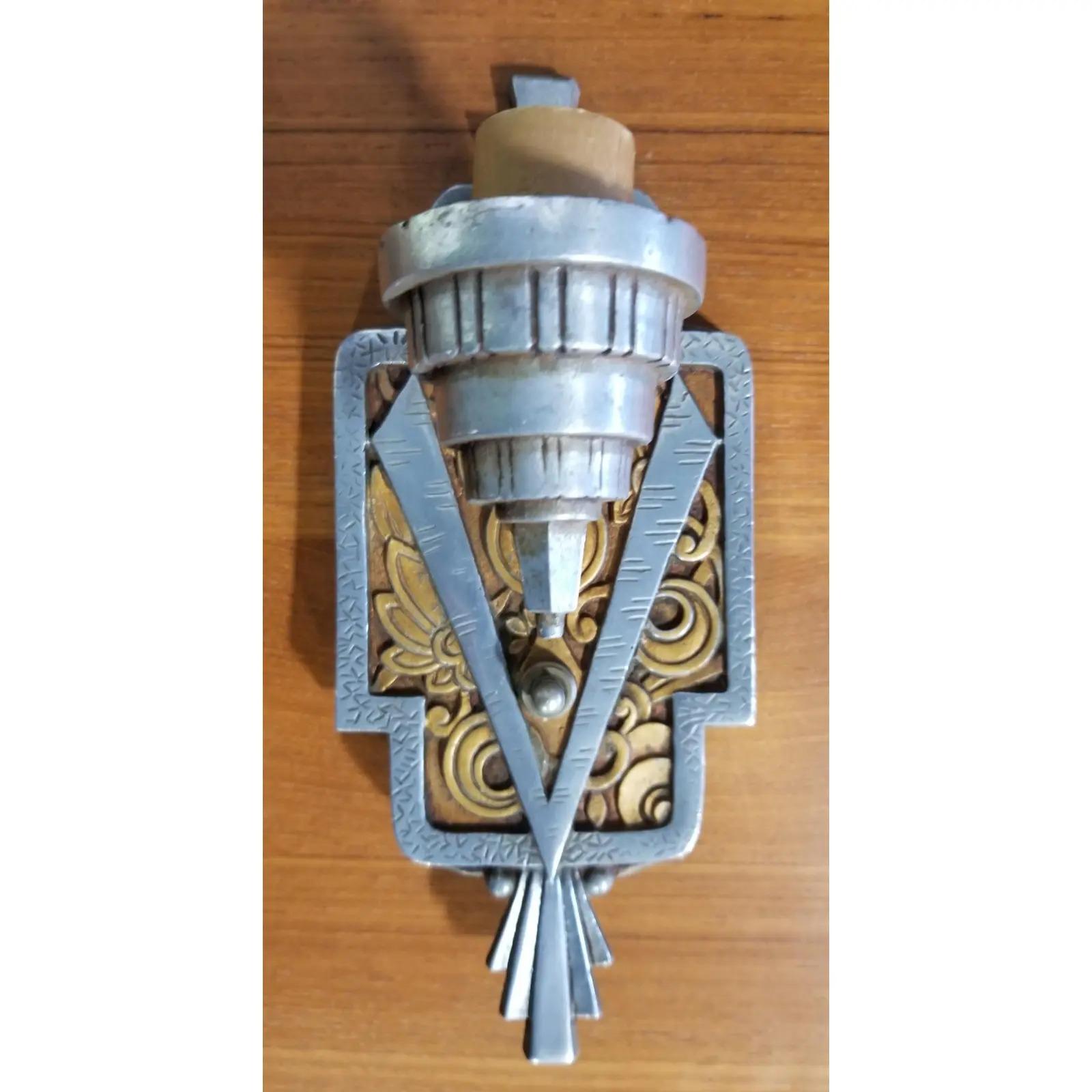 Striking Art Deco wall sconce with exceptional, iconic Art Deco design including original satin glass deep pressed art glass shade. Cast aluminum base plate with original painted finish. Original wiring in working condition. Features a button switch