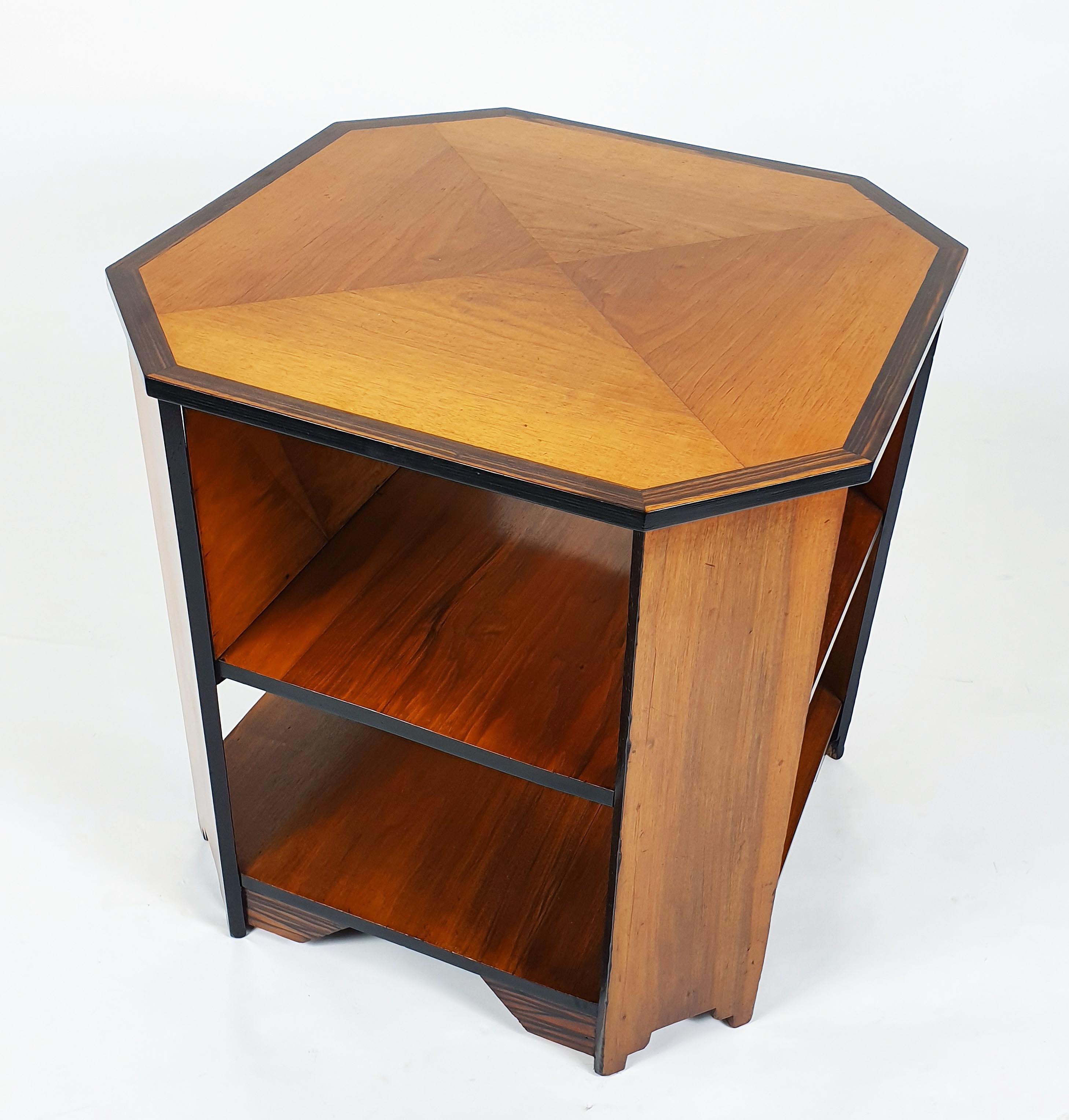 This attractive and well-proportioned Art Deco walnut center table with coromandel trim is octagonal in shape with shaped supports and a central shelf. The table measures 27 3/4 in - 75 cm in both diameter and height and a beautiful rich patina.