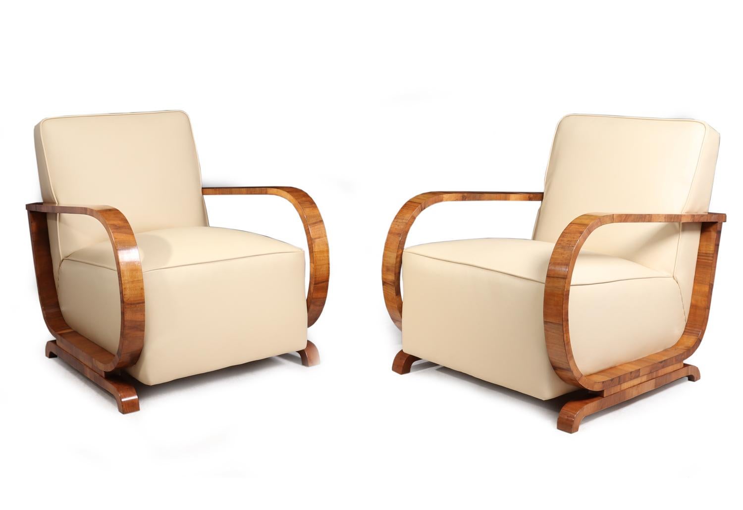 Art Deco walnut and leather armchairs, circa 1930
A pair of Art deco Leather and walnut framed armchairs, fully upholstered and covered in top grade cream leather hyde with piped detail, the walnut arms have been fully hand polished, the chairs are