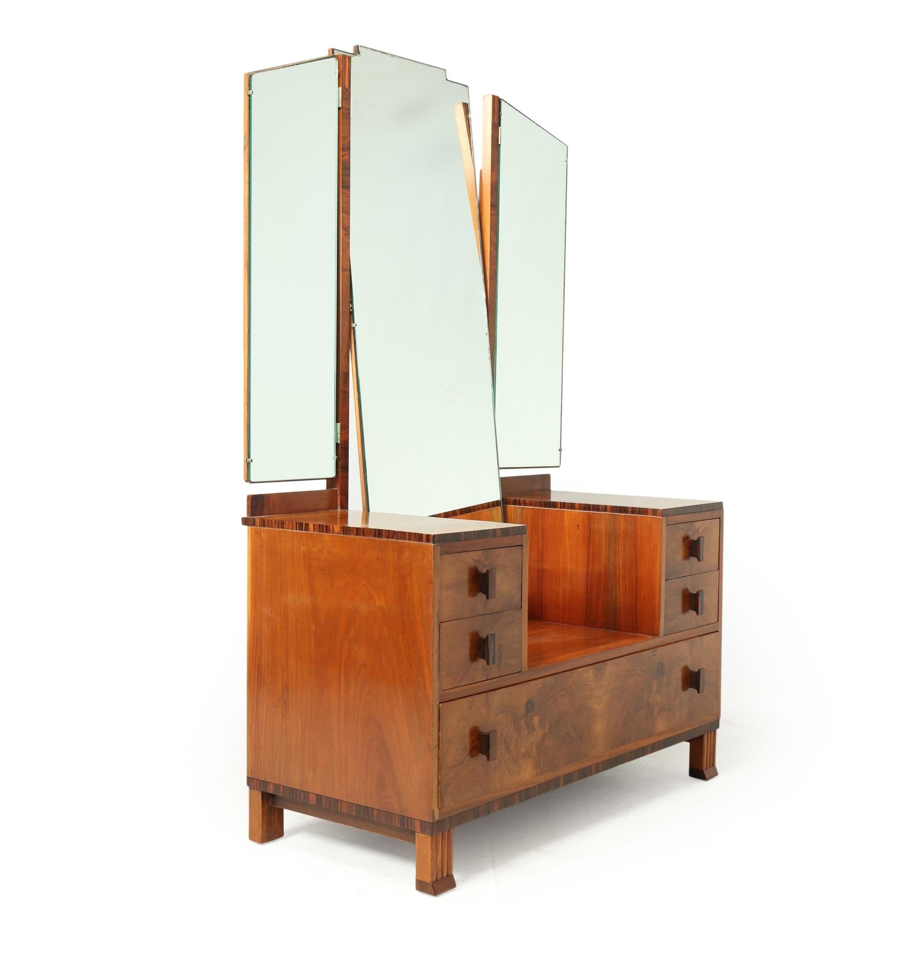 A beautiful dressing table produced in the 1930’s by renowned furniture makers Waring and Gillows. It has one long drawer to the bottom and two smaller drawers each side above all have macassar ebony handles the central mirror tilts back and forward
