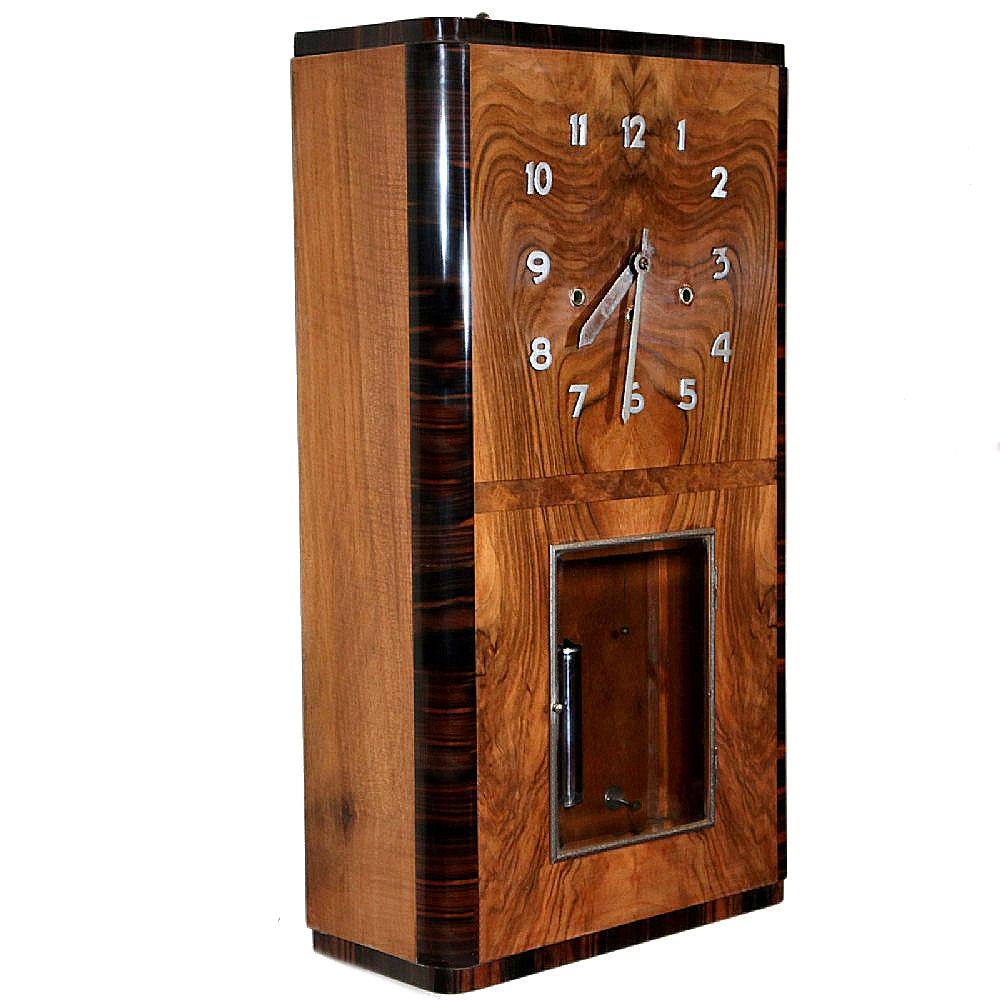 For your consideration is this superbly stylish and rare 1930s Art Deco wall clock. The case is absolutely stunning with heavily figured honey coloured veneers to the case body with Macassar ebony banding around the edges. Simple raised chrome