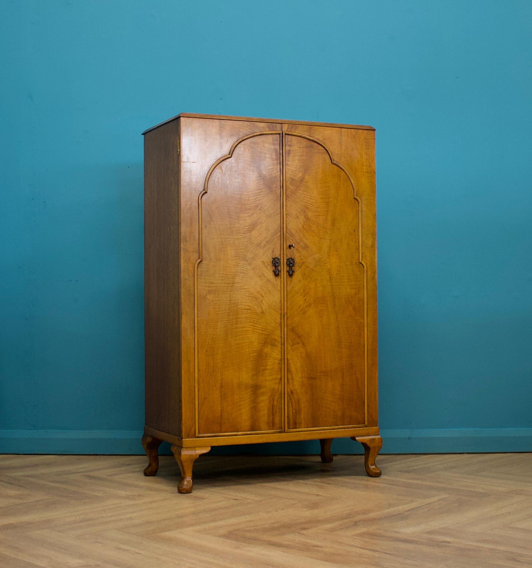 -An impressive quality Art Deco burr walnut tallboy or housekeeper’s cupboard
 
Made by Waring and Gillow, circa 1930s
 
Standing on Queen Anne style feet
 
Featuring a pull-out shelf and an additional two fixed
 
This piece is extremely versatile,