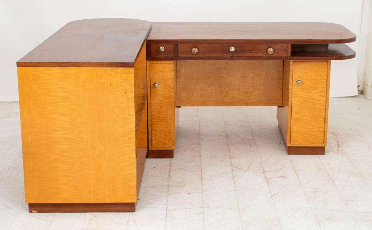 Art Deco Walnut and Birch L-Shaped Desk, 20th century with three drawers above two cabinets, the rounded return with a two-tier bookshelf and two open shelves to reverse. 30.5