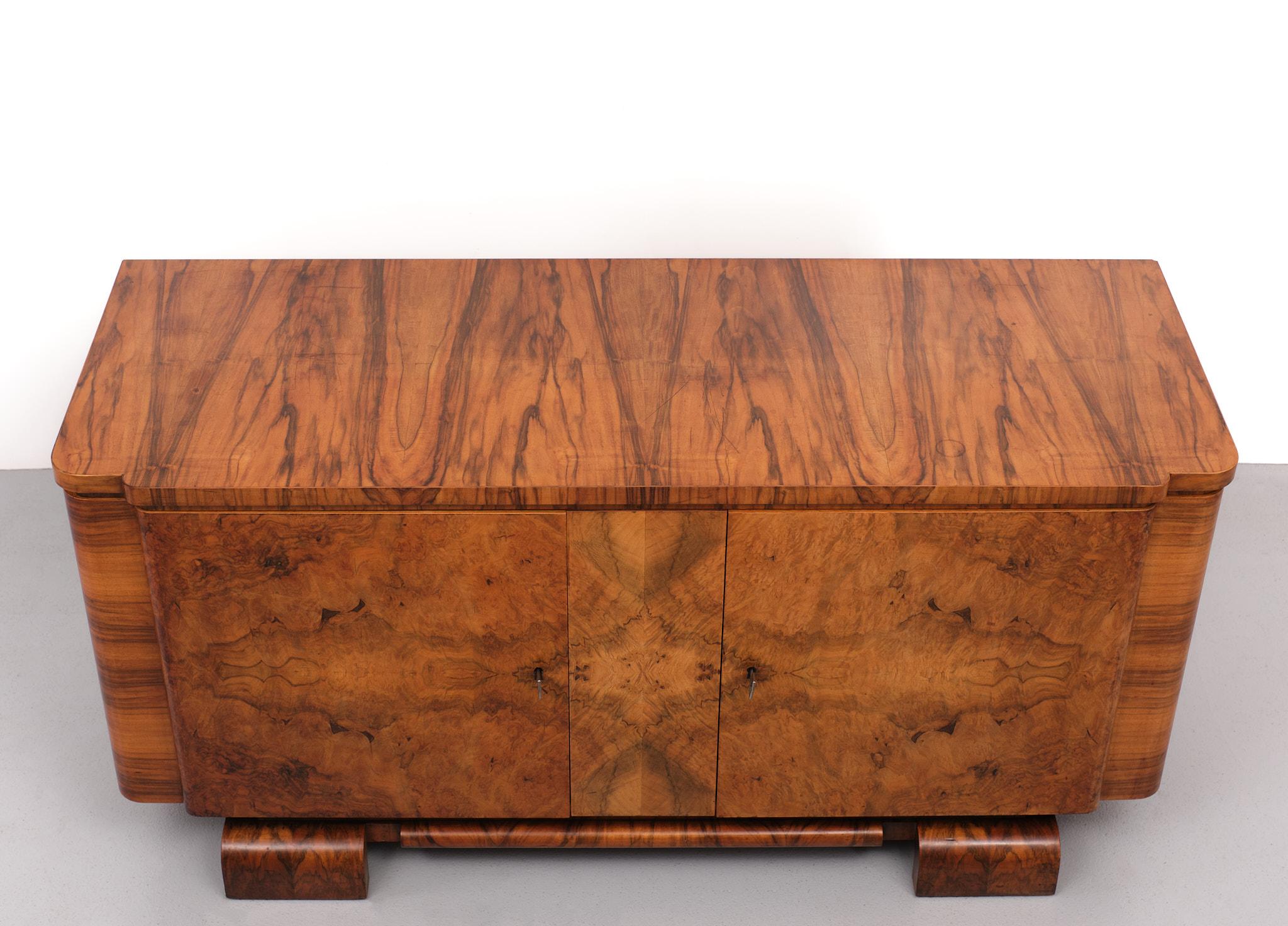 Beathiful Art Deco sideboard. Superb book matched walnut burl veneer. On the front.
Love all its curves. Original working keys. One shelve. Great details on this piece. 
Normal users marks on the top.