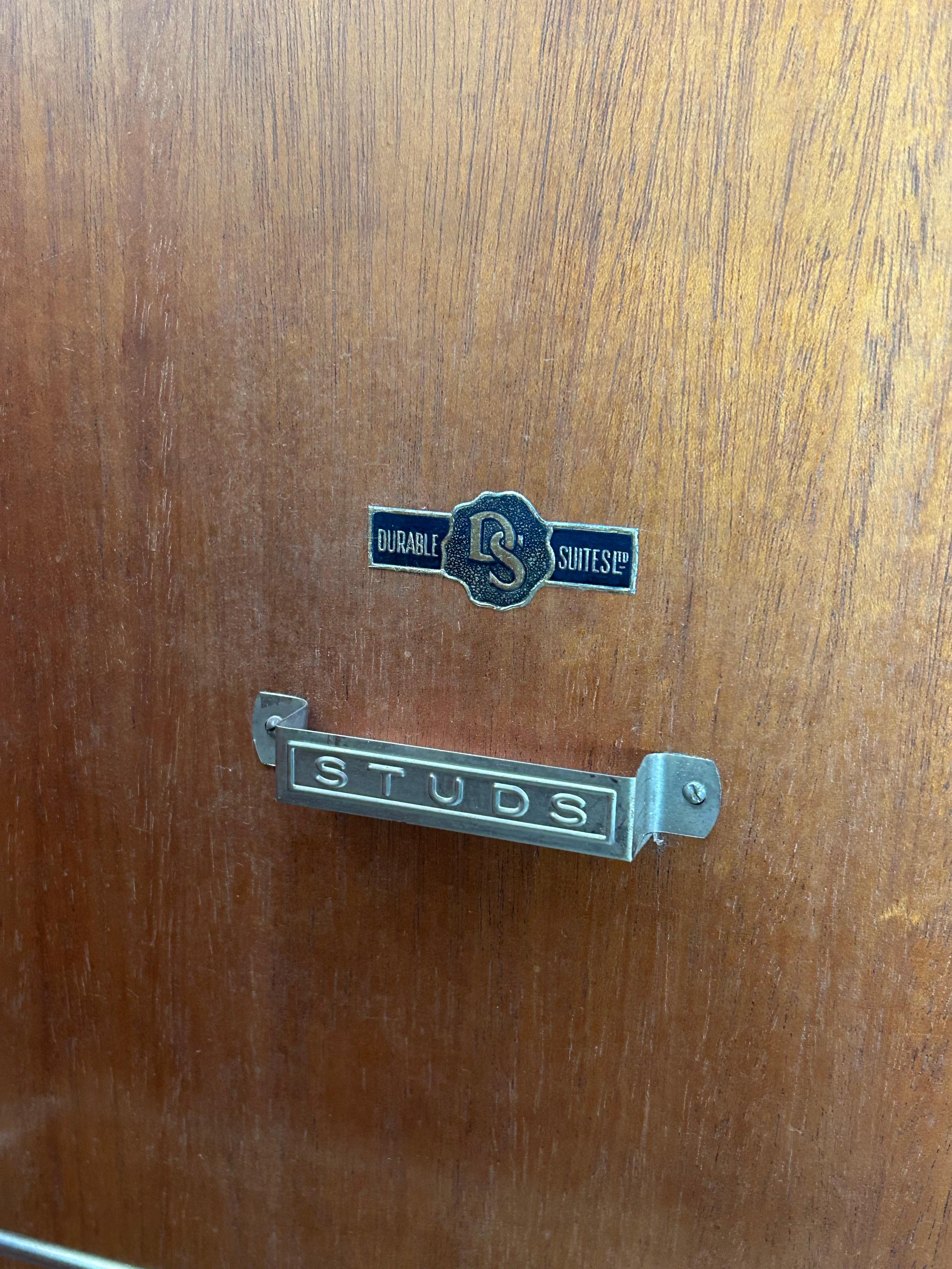 Striking Art Deco wardrobe crafted in England in the late 1920s, with a strong visual presence and exceptional materials. This piece is made from walnut burl veneer, offering a rich, warm tone and a beautifully expressive grain pattern that reflects
