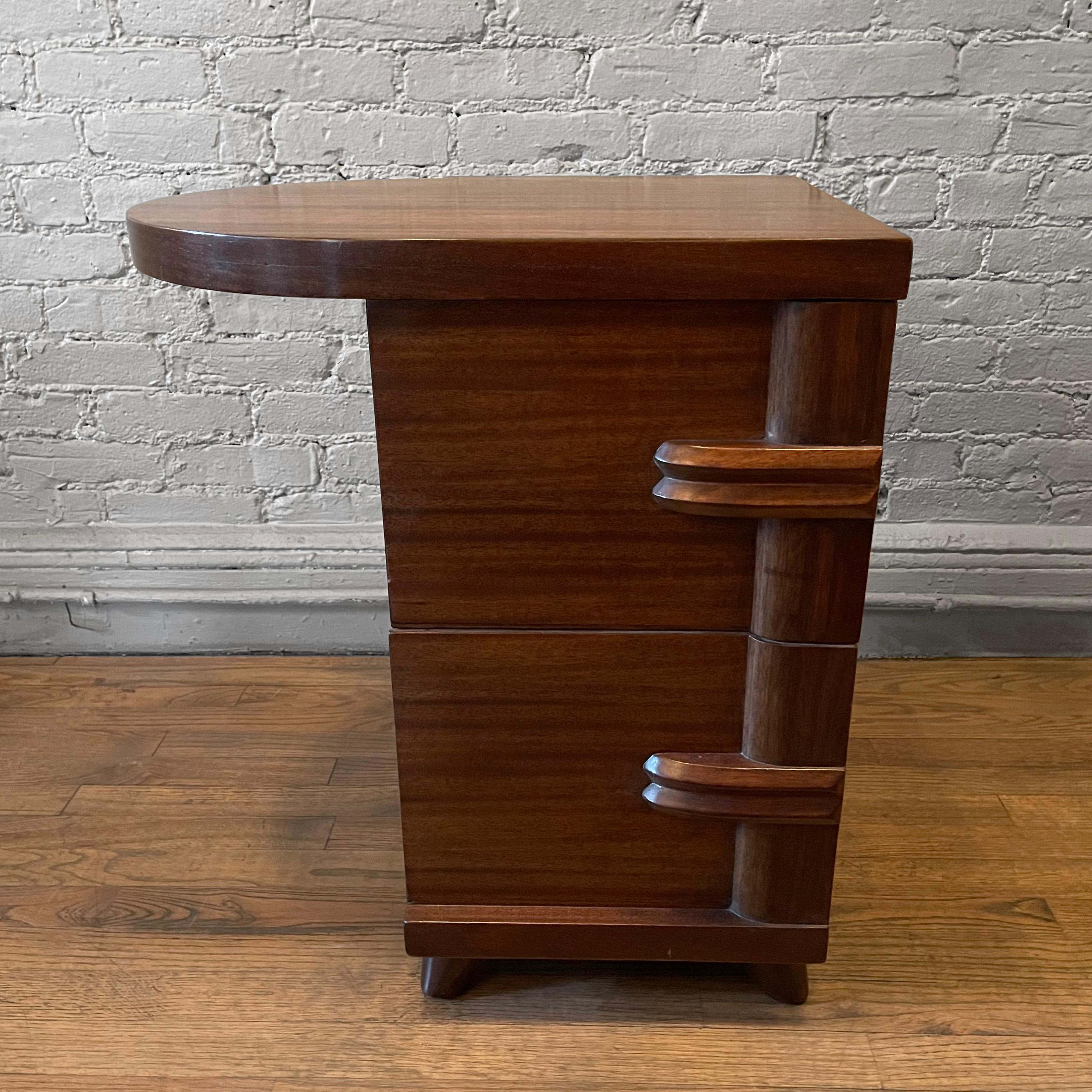 Art Deco, single, two drawer, walnut end table or nightstand features wonderful decorative elements like curved pulls and a rounded cantilever top.