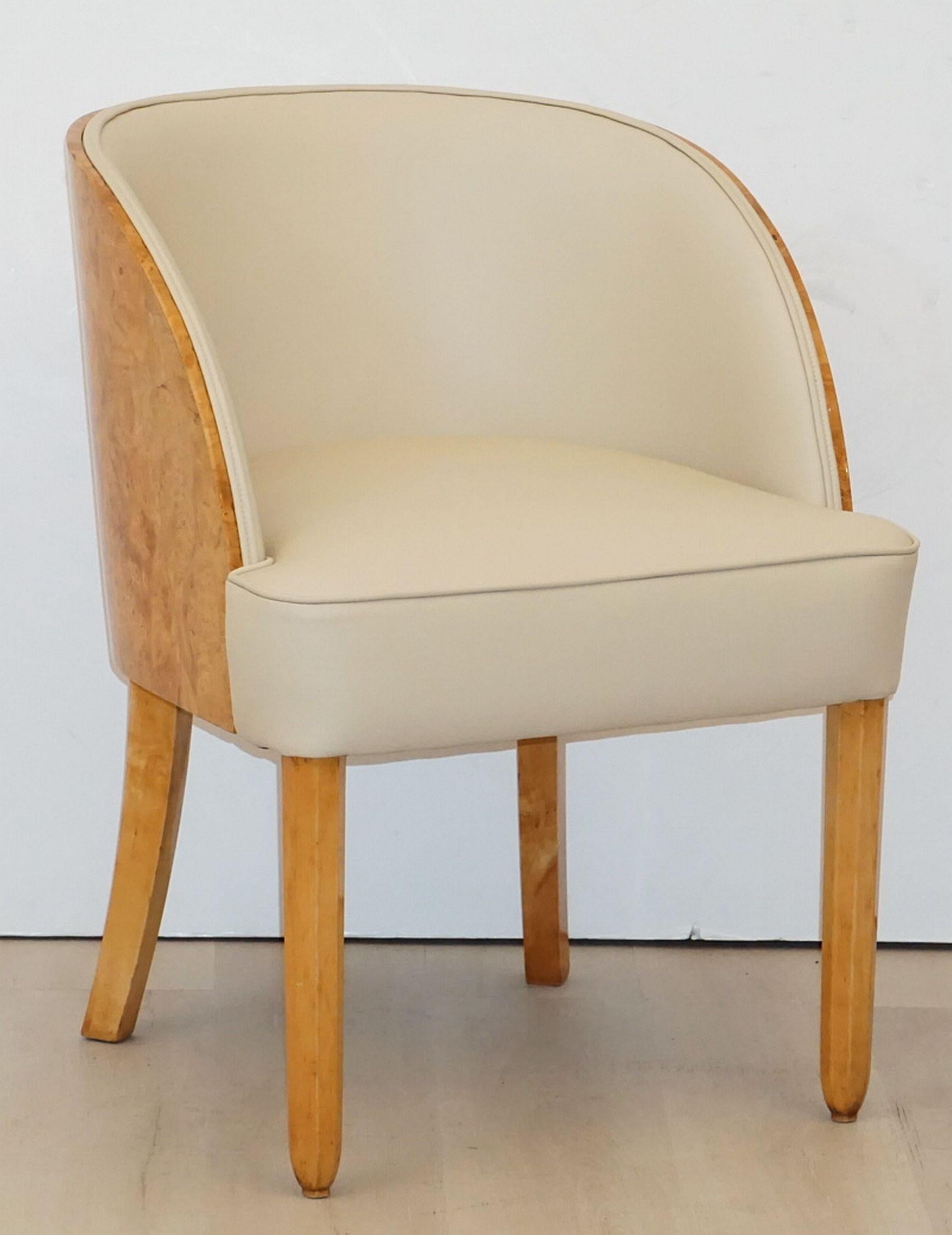 A comfortable English tub chair from the Art Deco period, featuring a bleached walnut veneer, re-upholstered back and seat in cream leather, on tapering chamfered legs. Attributed to Harry & Lou Epstein.

Cabinet makers: H.& L. Epstein, London.