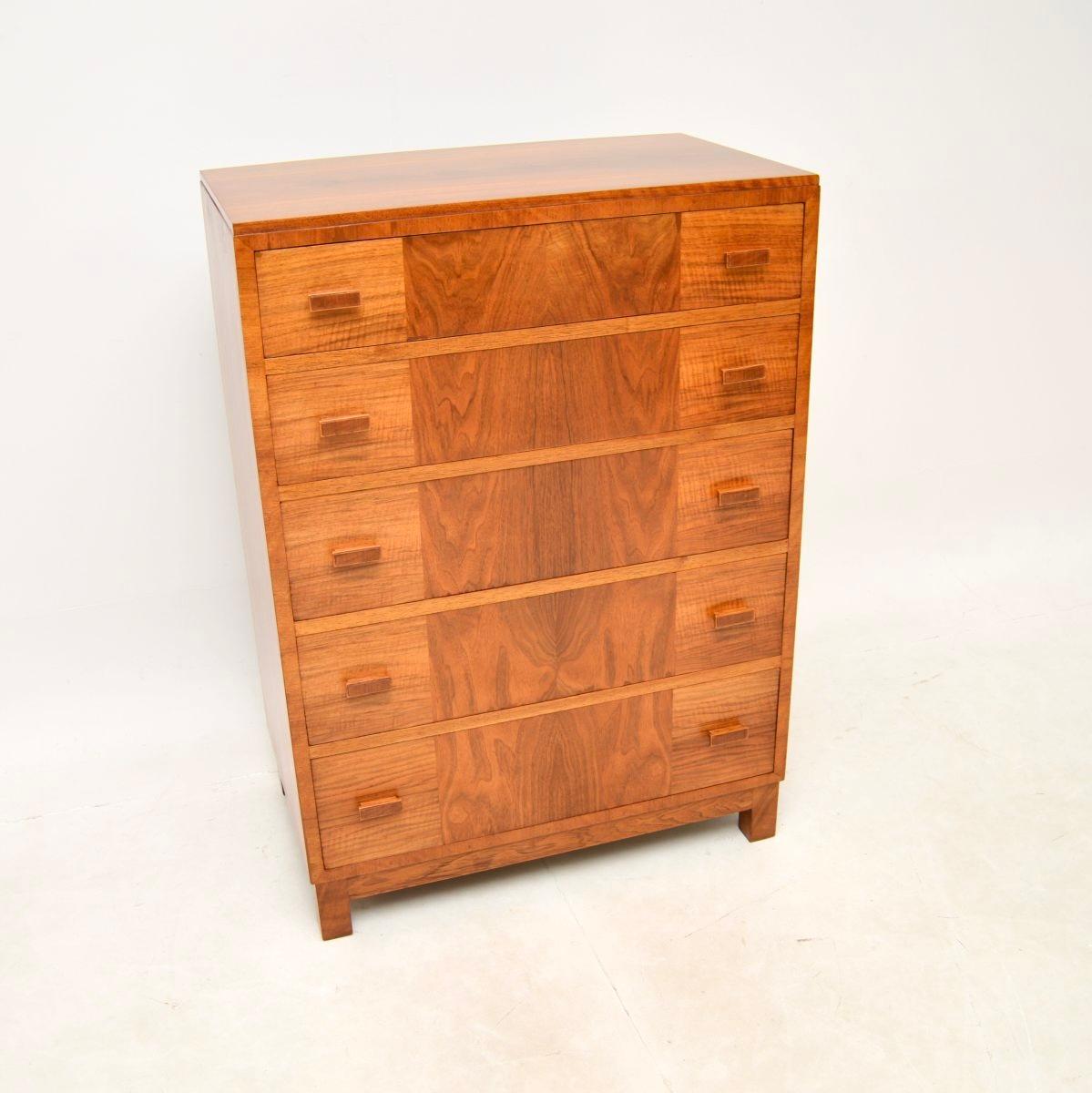 A stylish and extremely well made Art Deco walnut chest of drawers by Heal’s. This was made by and retailed in Heal’s in the 1920-30’s.

The quality is exceptional, with a very solid construction and gorgeous walnut grain patterns. There is lots of