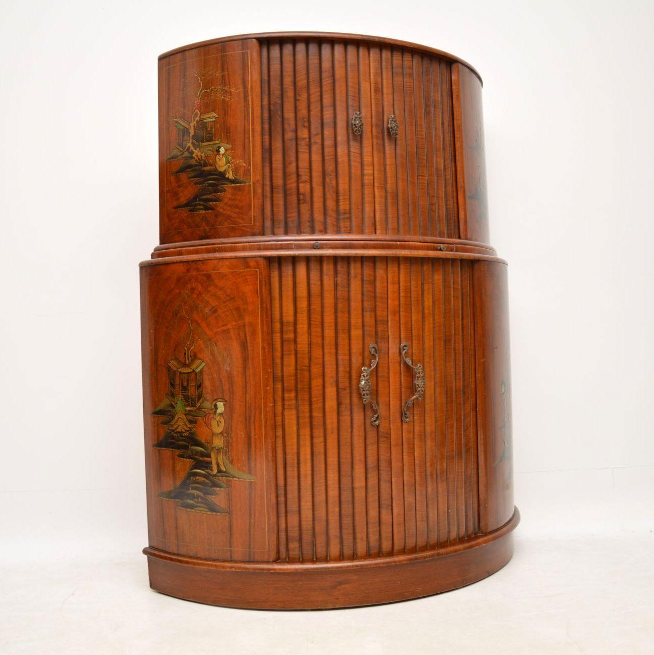 A beautiful and quite unusual vintage walnut cocktail cabinet from the Art Deco period, this dates from around the 1930s-1950s. It has a lovely demi lune shape, with tambour doors at the top and bottom, and ample storage space for glasses and