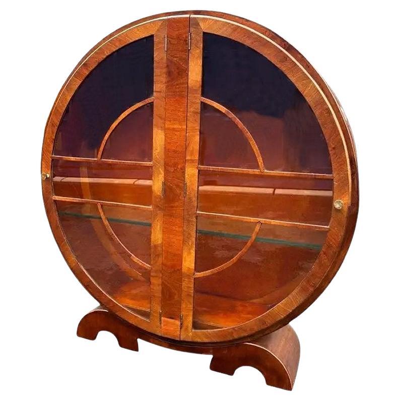 A wonderful 1930's Art Deco circular display cabinet of high quality, with ample storage on 3 glass shelves and lovely bakelite handles all sat on superb double circular feet. In great condition having been fully restored and French polished. This