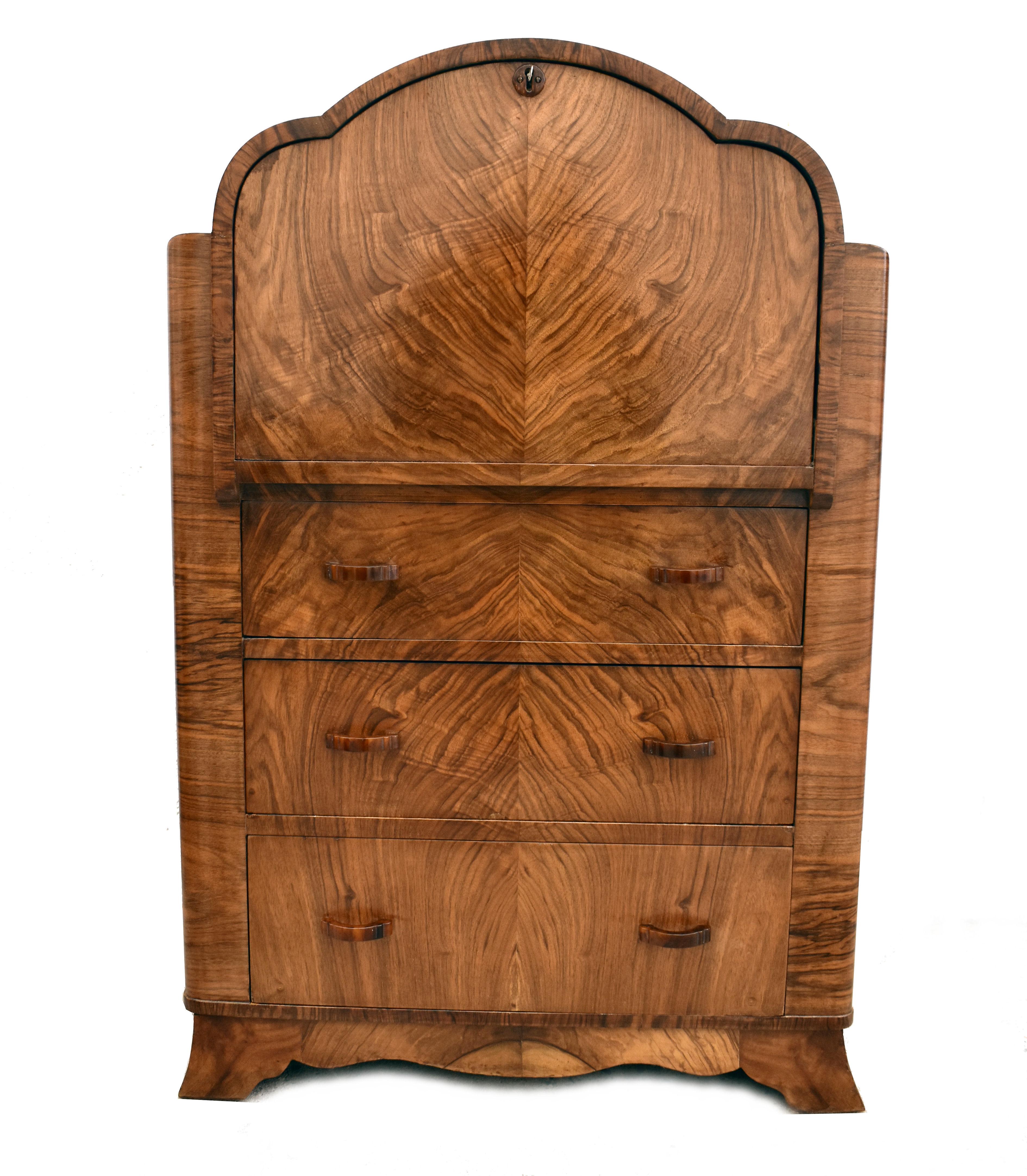 This is a fantastic 1930s Art Deco bureau of smaller proportions, a really superb piece of furniture. book paged veneers in a lovely light toned figured walnut with three generous sized drawers to the base and a pull down top which reveals a desk