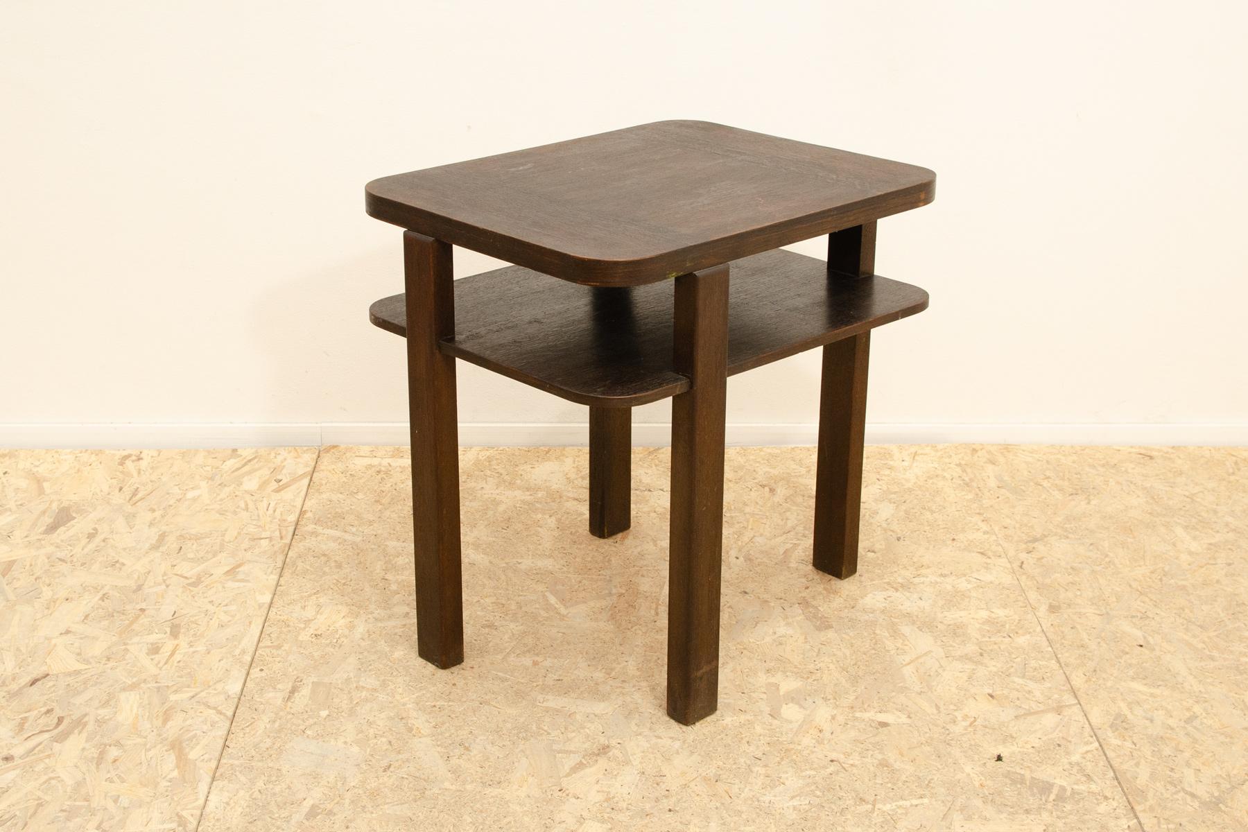 This ART DECO coffee table was made in the 1930s in the former Czechoslovakia. It is based on the original and almost classic design of Thonet, which also produced this type of table. It is made of dark stained beech wood. Considering its age, it is