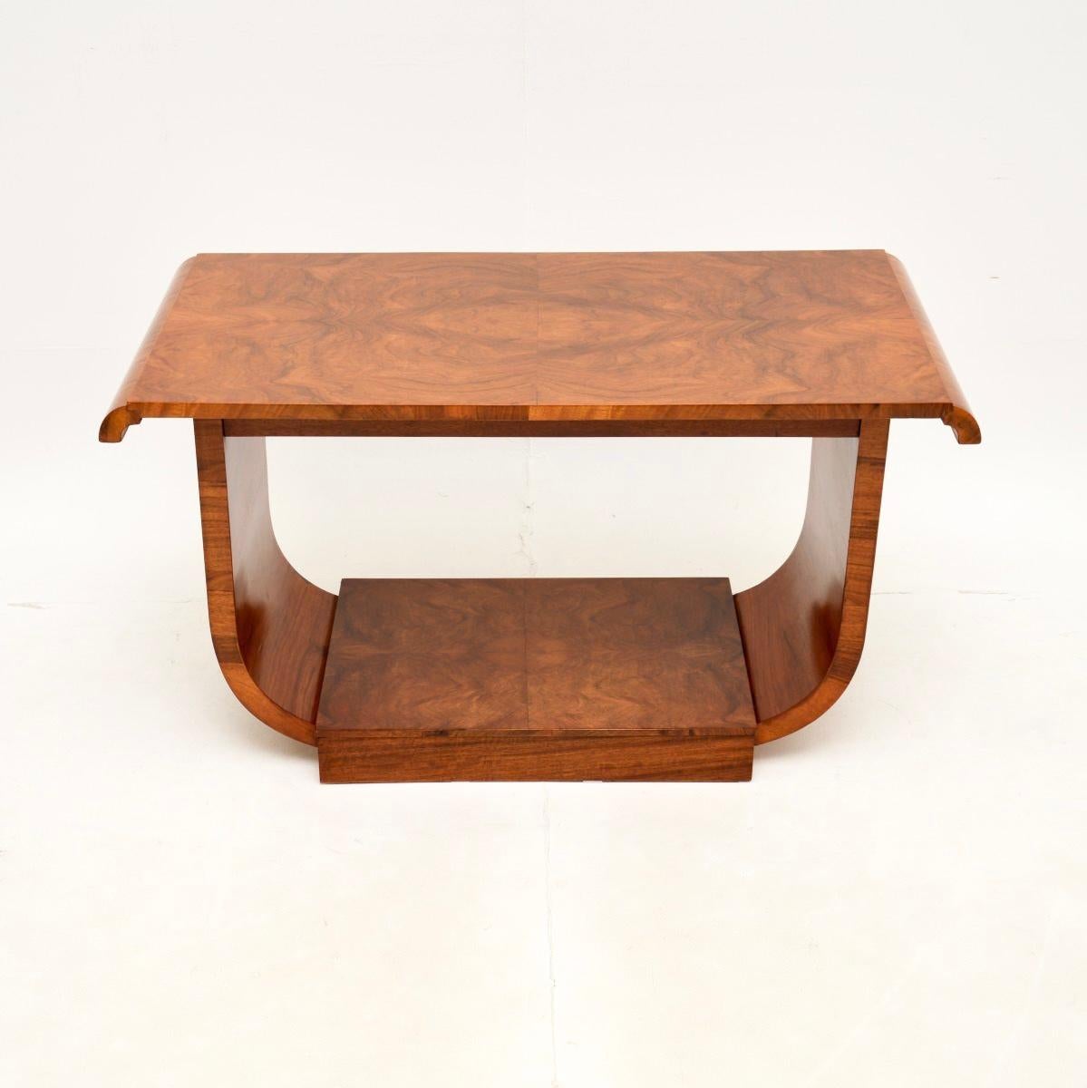 A smart and extremely well made Art Deco walnut coffee table. This was made in England, it dates from the 1920-30’s.

It is of exceptional quality and is a very useful size. It stands on a beautifully designed U shaped base with useful lower tier.