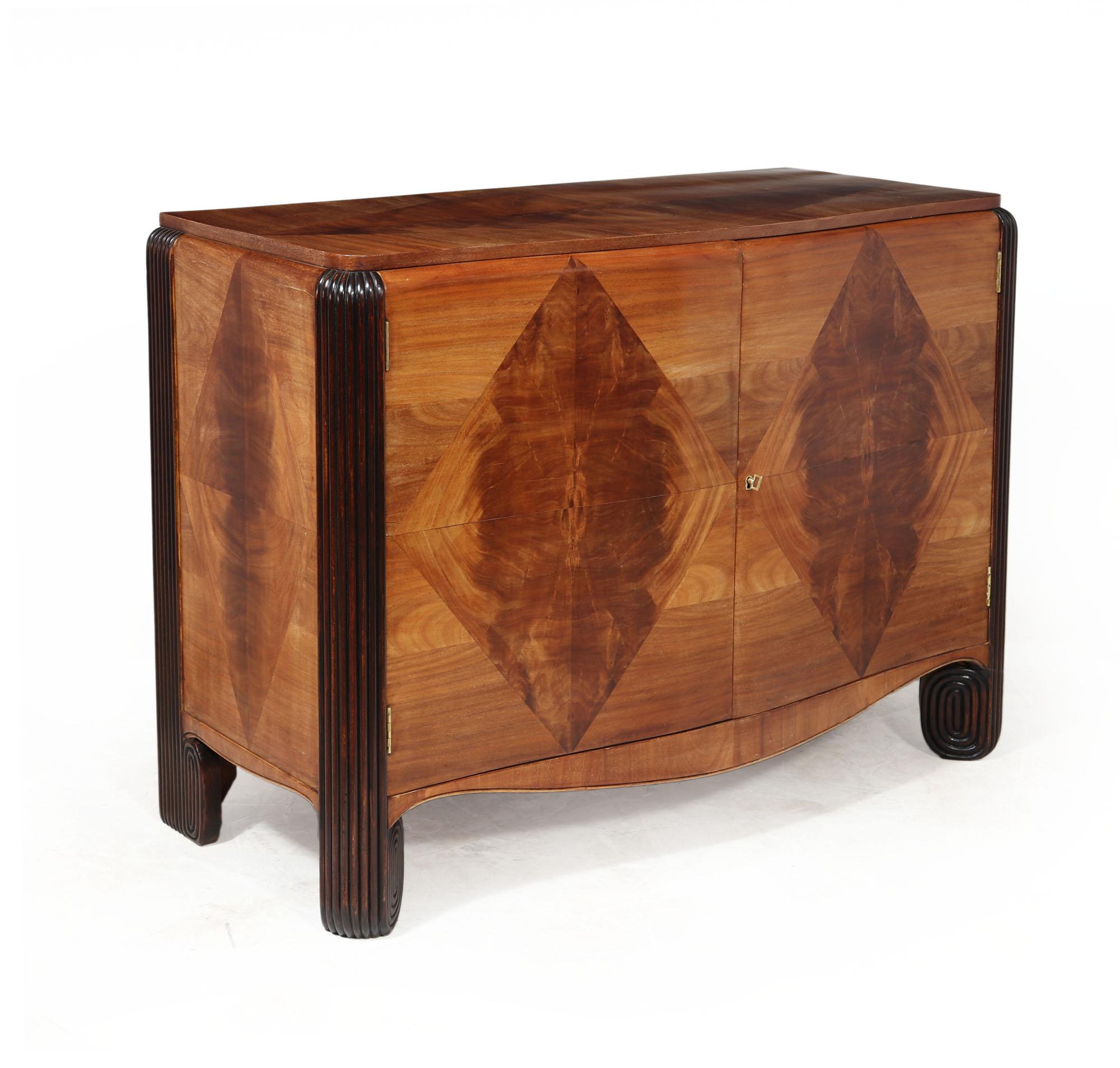 WALNUT COMMODE BY MICHEL DUFET
An exceptional and rare commode by Michel Dufet produced in France in c1925, in Walnut on Oak, having inlayed contrasting walnut in diamond form, reeded leg uprights, serpentine shaped front with for drawers behind