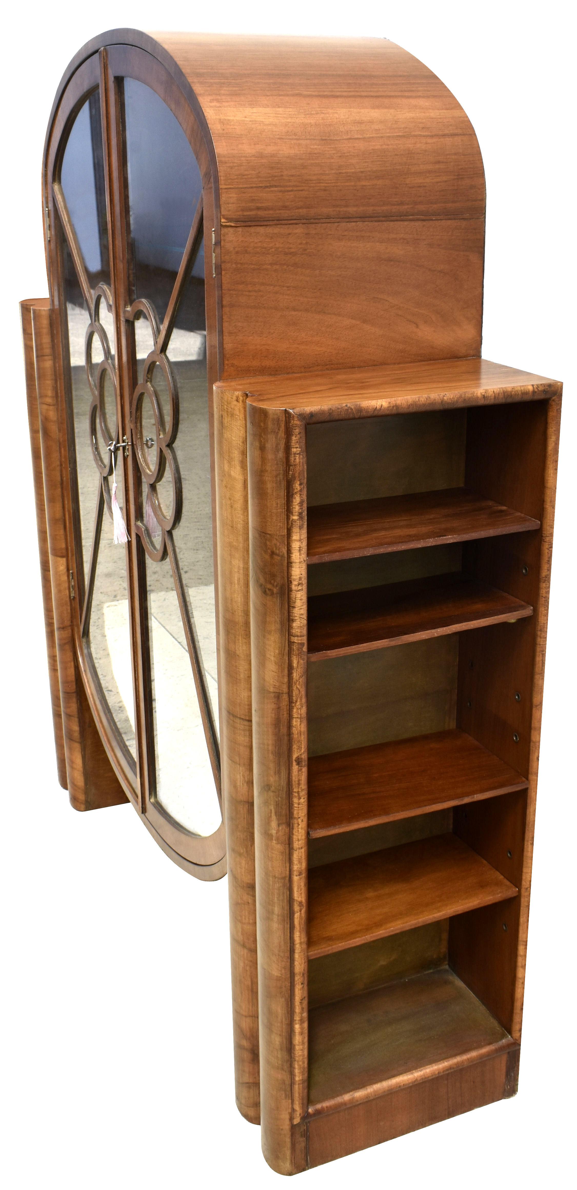 This is a fabulous opportunity to acquire a genuinely rare design Art Deco display cabinet. Dating to the 1930's this gorgeous mid-tone walnut, still with original working key and three glass shelves and usable bottom shelf. Generously spaced