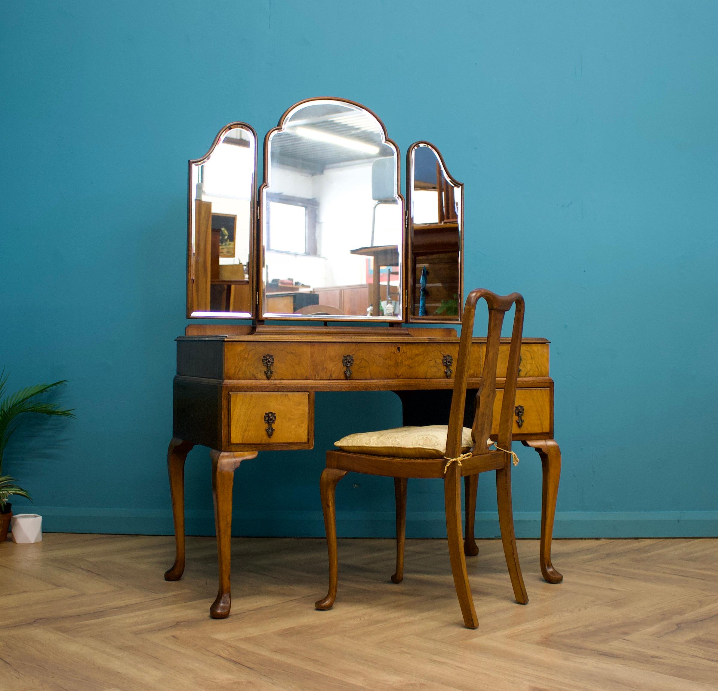 An impressive quality Art Deco burr walnut dressing table


Made by Waring and Gillow, circa 1930s


Standing on Queen Anne style legs


Featuring five drawers with metal drop handles, and a matching dressing table chair


There is also a triptych