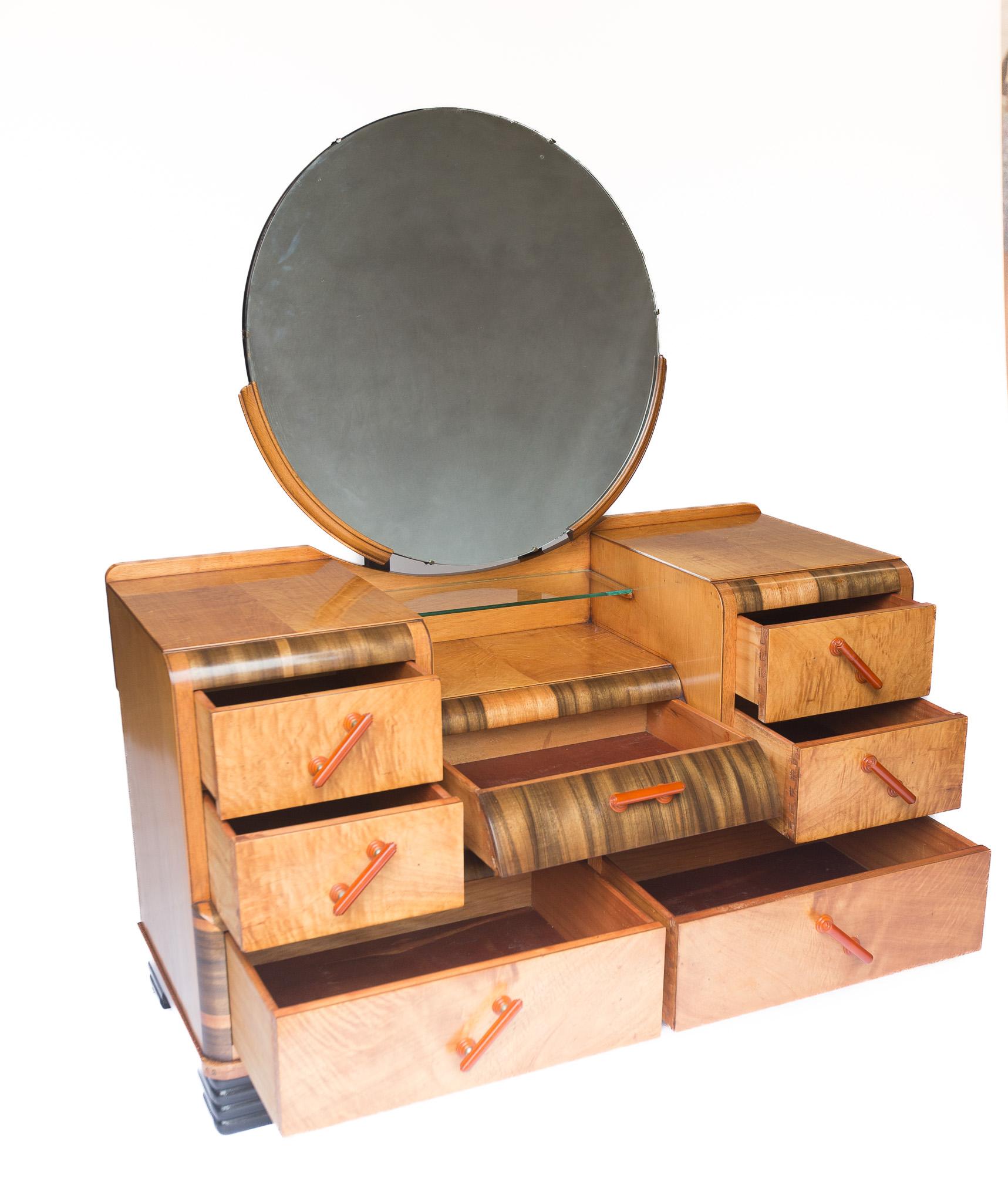Art Deco Walnut Dressing Table circa 1930s, 
Very stylish with dark cross grain walnut veneer, 
& lighter figured walnut veneer
Circular bevelled mirror, one small foxing dot at top
Drop Centre section, with plate glass shelf, &
Centre drawer
