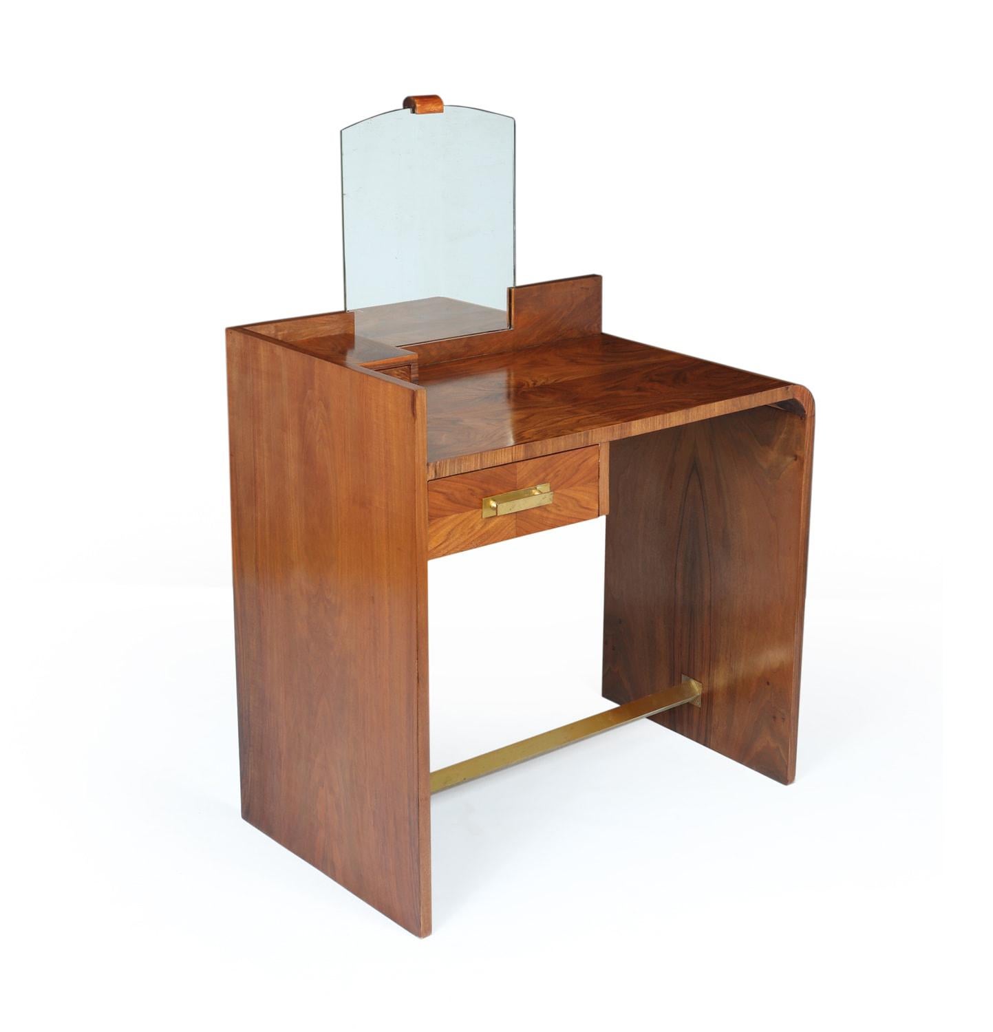 Art Deco Walnut Dressing Table
A French art deco dressing table with two drawers and original mirror and brass handles and foot bar, the dressing table has bee fully polished and is in very good condition throughout

Age: 1930

Style: Art