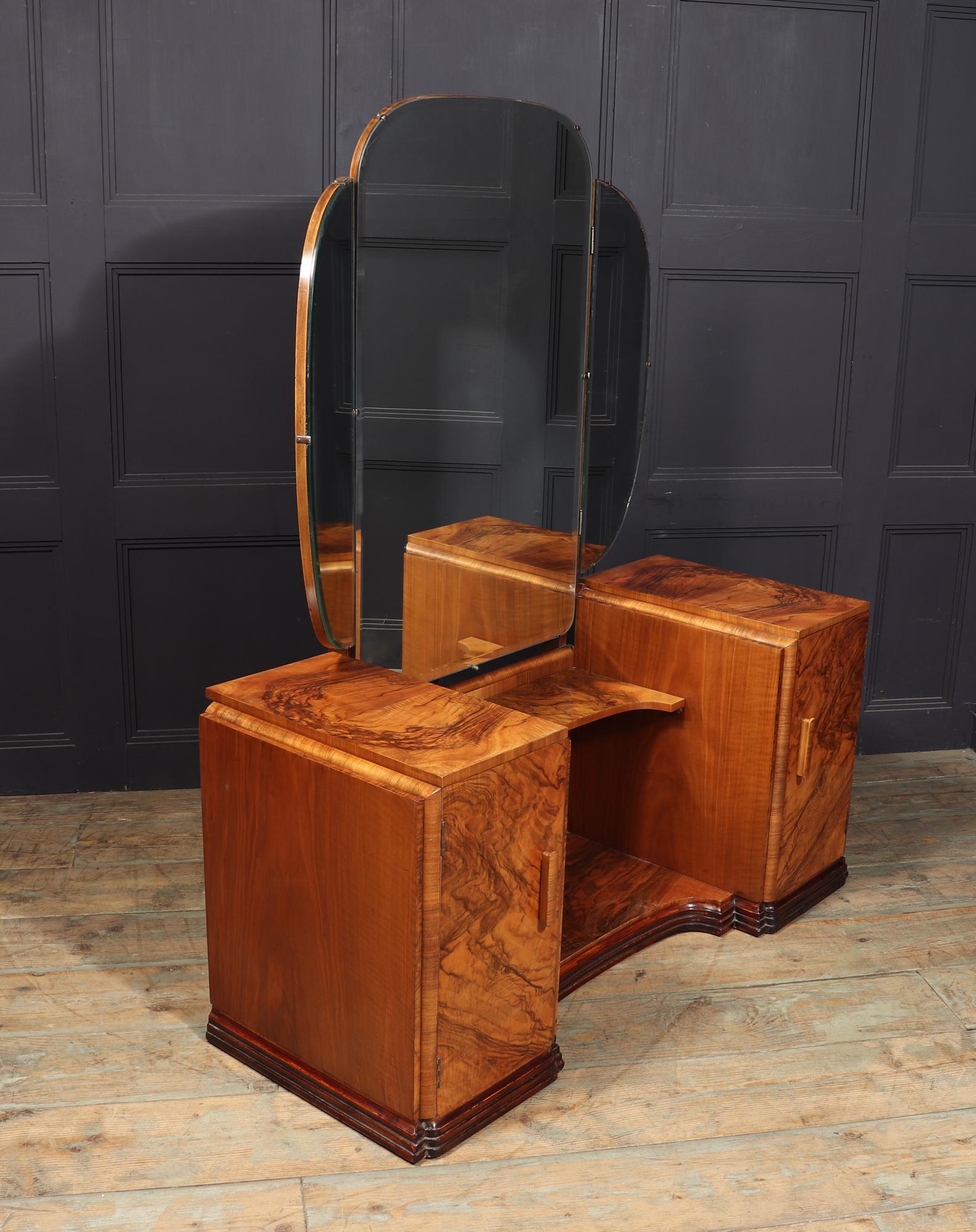 ART DECO DRESSING TABLE
This exquisite English Art Deco dressing table in walnut is truly a sight to behold. With its triple folding shaped mirror, central shelf, and cleverly designed cupboard doors, this piece exudes elegance and functionality.