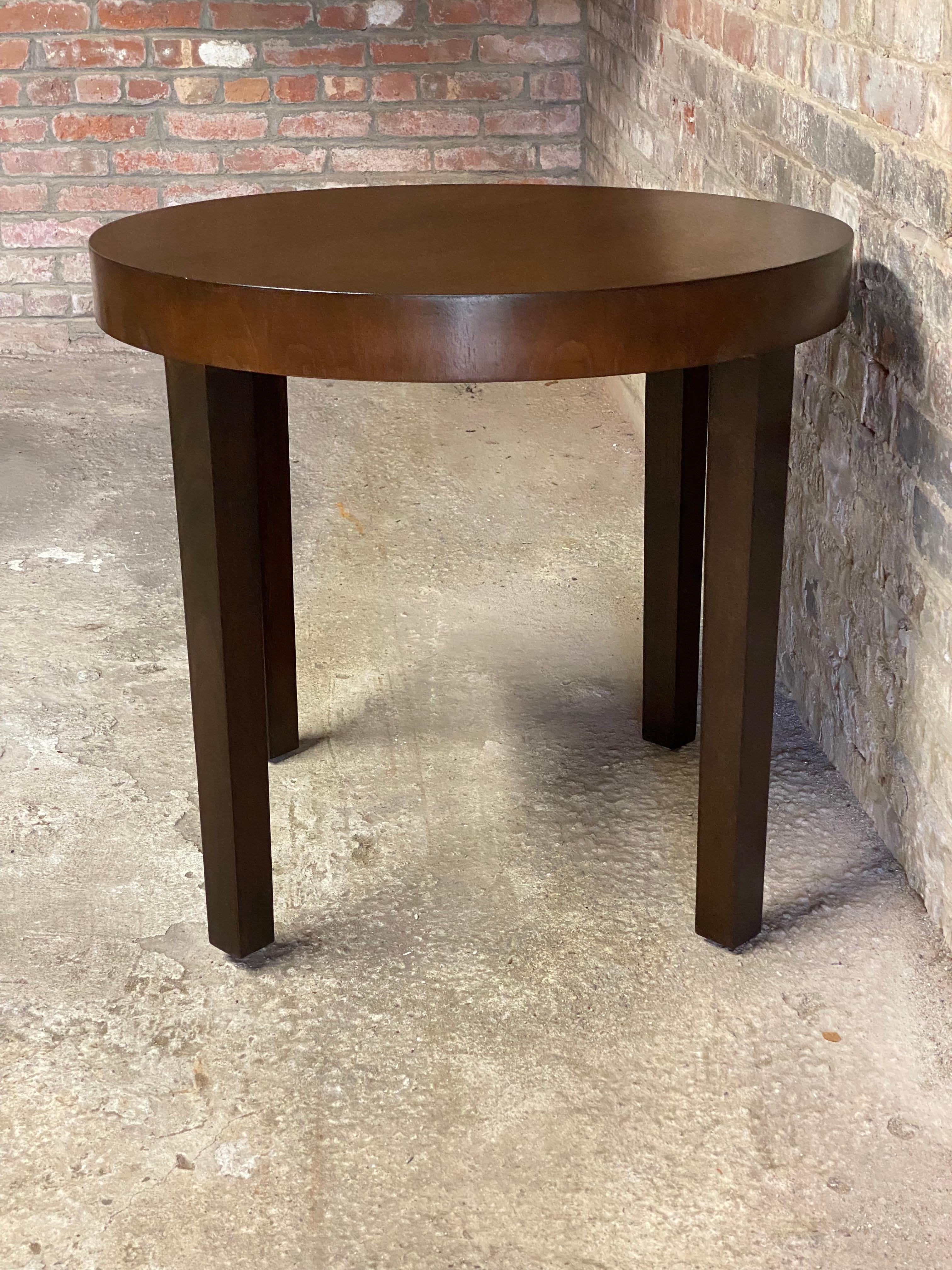 Simple and refined walnut Art Deco drum table. Block legs with a deep drum top. Good overall condition with some minor scratches and some veneer losses along the edge (see photos). Older deep chocolate brown refinish. Wear commensurate with age and