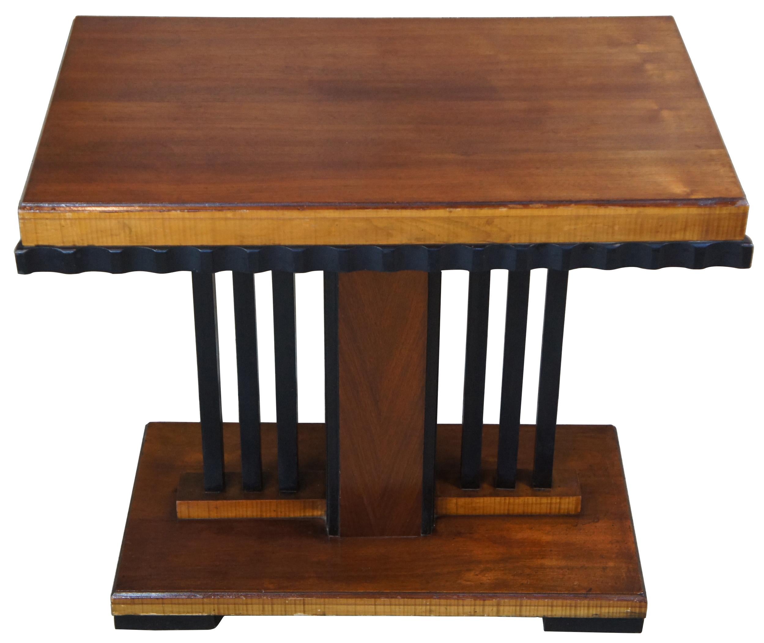 Art Deco era console or side table. Made from walnut with an ebonized ruffled apron over a slatted central support leading to base. Central column features matchbook veneer.
 
