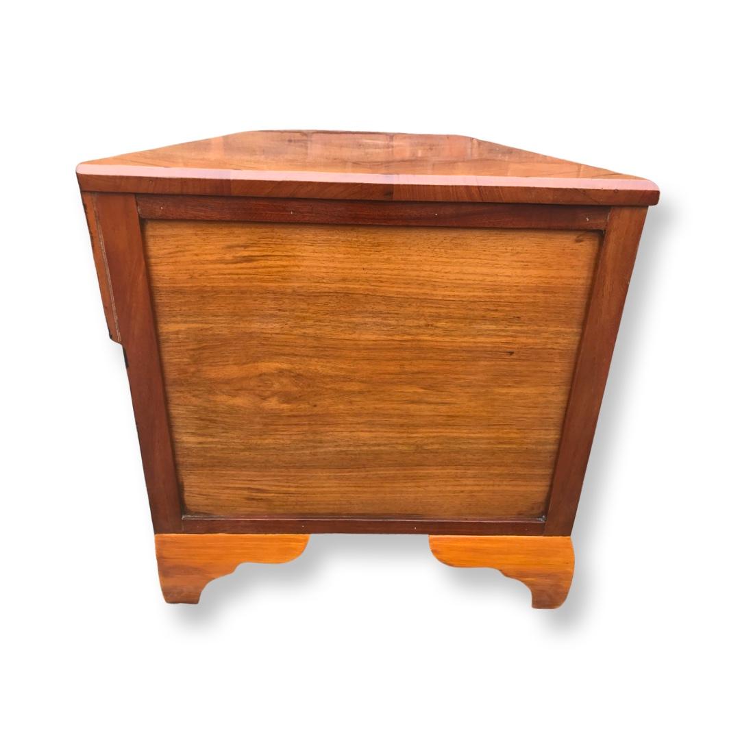 An attractive Art Deco walnut geometric low chest of drawers consisting of one full width drawer with 2 smaller drawers above all dovetailed and working smoothly. This chest stands on its original cushion bracket feet finished in a pale lacquered