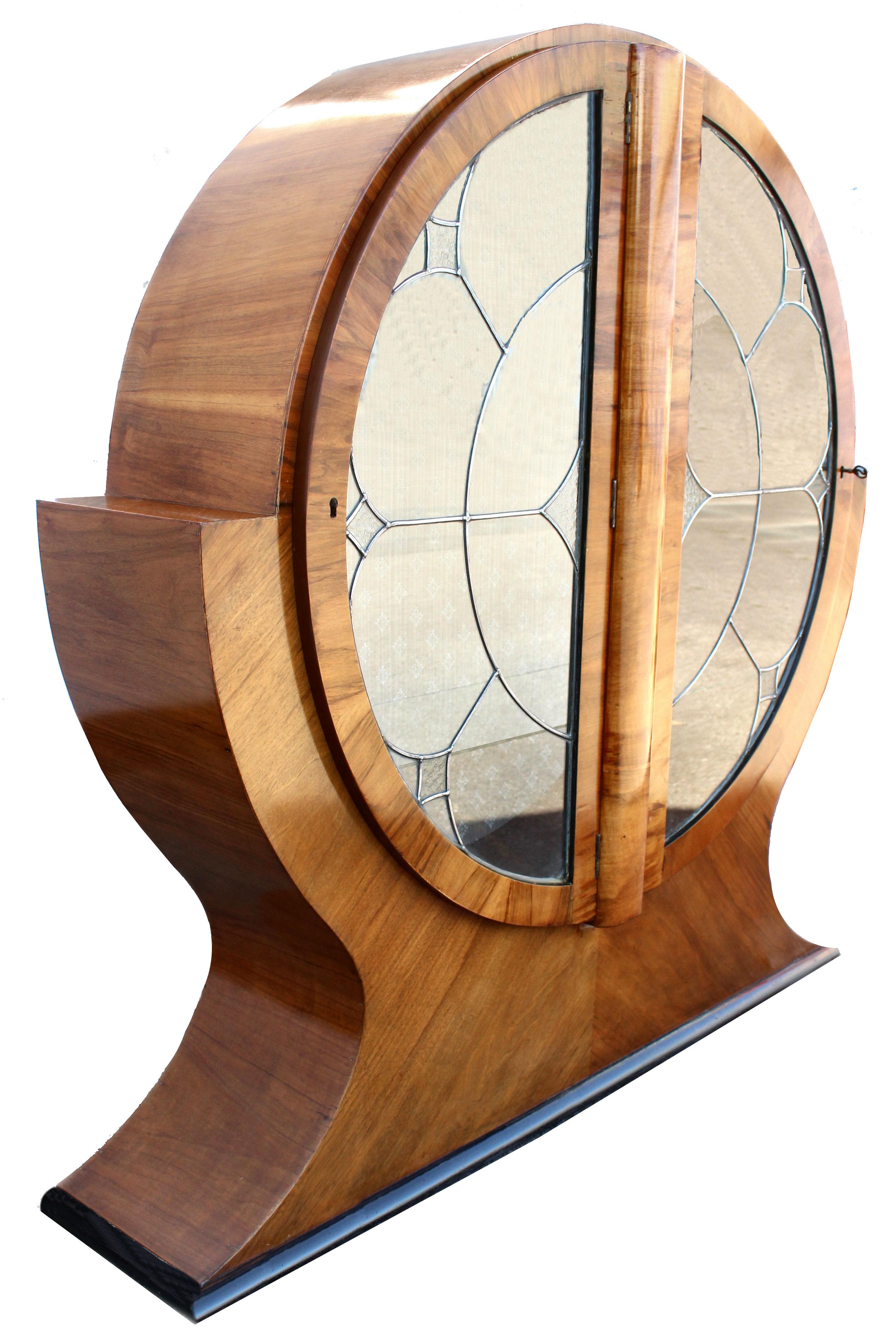 This is a superbly stylish 1930's Art Deco display cabinet. This walnut cabinet is what we've chosen to call a 