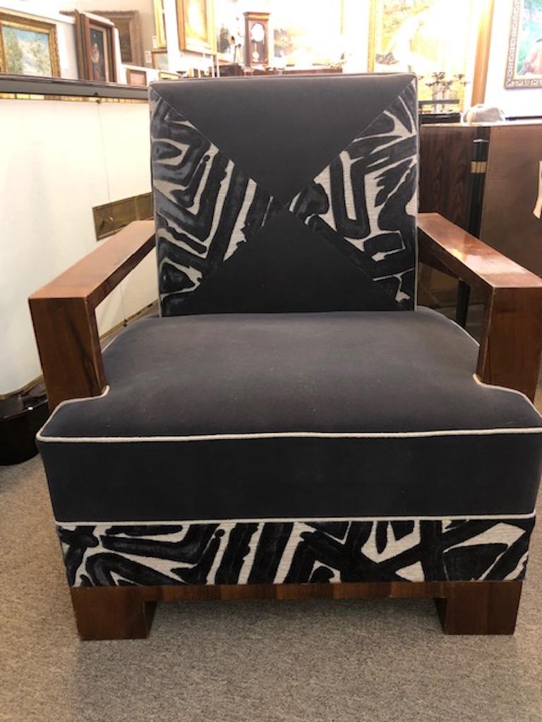 The chair is made out of high quality walnut wood. Re-polished and re-upholstered in a graphite color velvety fabric. The chair has wide rectangular arm rests and four square legs, which are elevating the chair.
Condition is excellent.
Priced