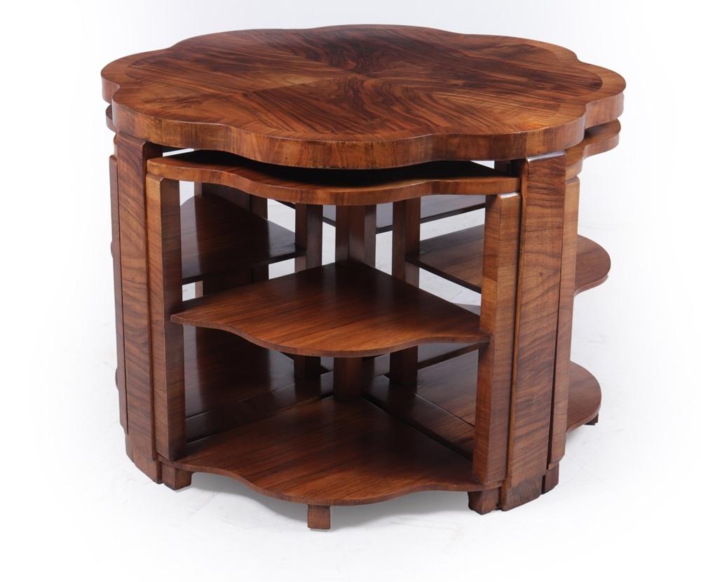 A shaped cloud nest of five tables in figured walnut with cross-banded top, the four smaller tables fit neatly underneath all tables are solid with no loose joints and have been fully polished.