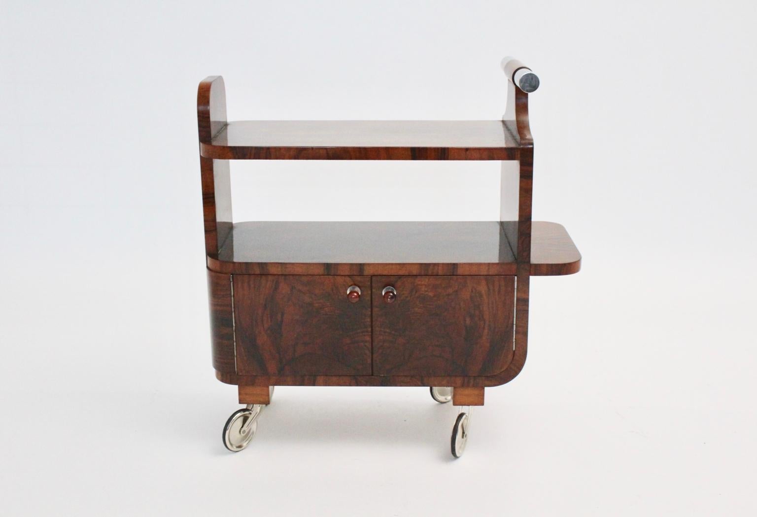 An Art Deco walnut nickel vintage bar cart, which was designed and manufactured in Vienna, circa 1930.
We are happy to present a beautiful Art Deco bar cart, which is usable for books or beverages also as side table or serving trolley. We love the