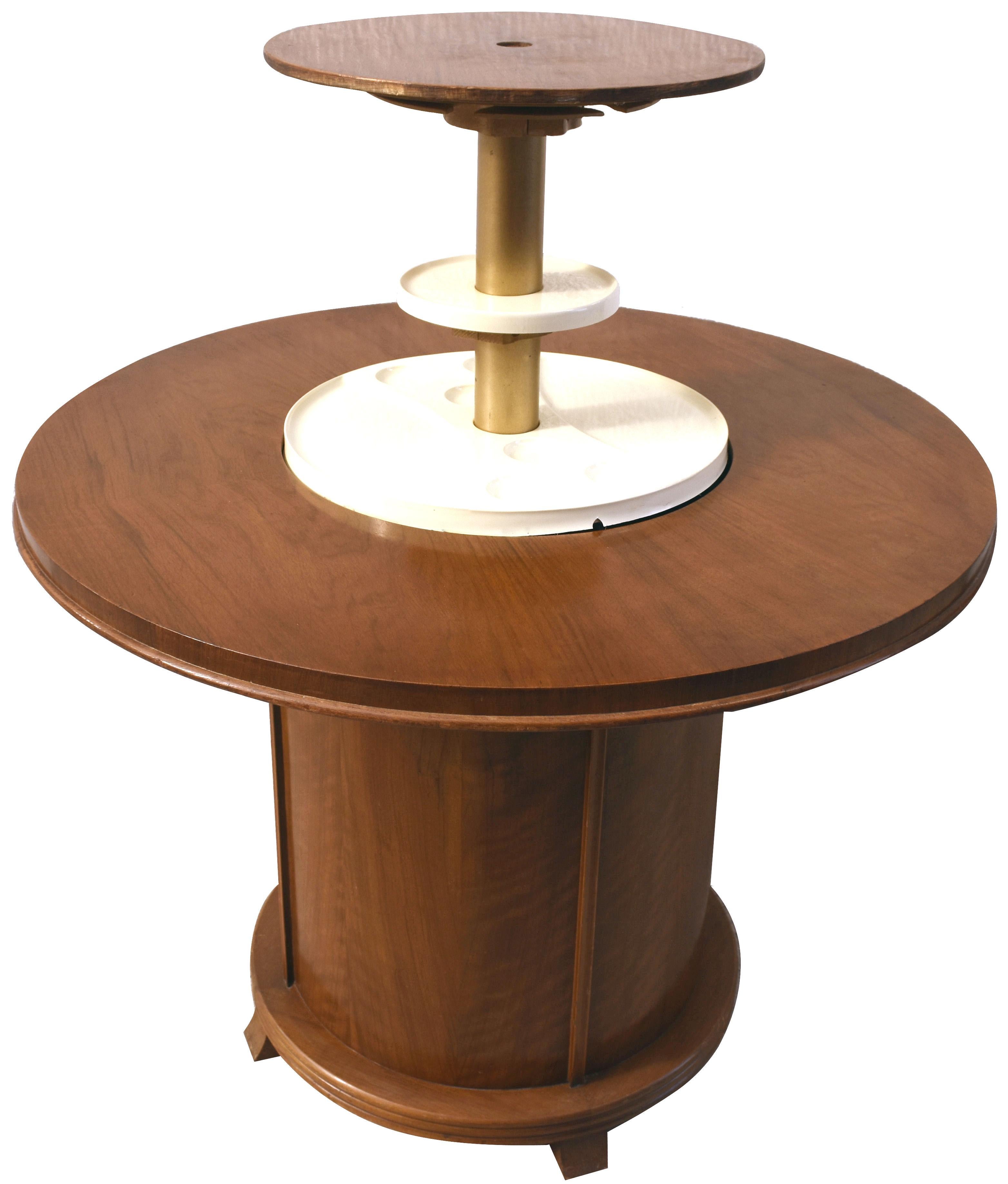 For your consideration is this rather fun and stylish original Art Deco English pop up cocktail table. When closed all you need do is press a central button which is centre to the table top and voila! up pops a second tier stored with glasses ready
