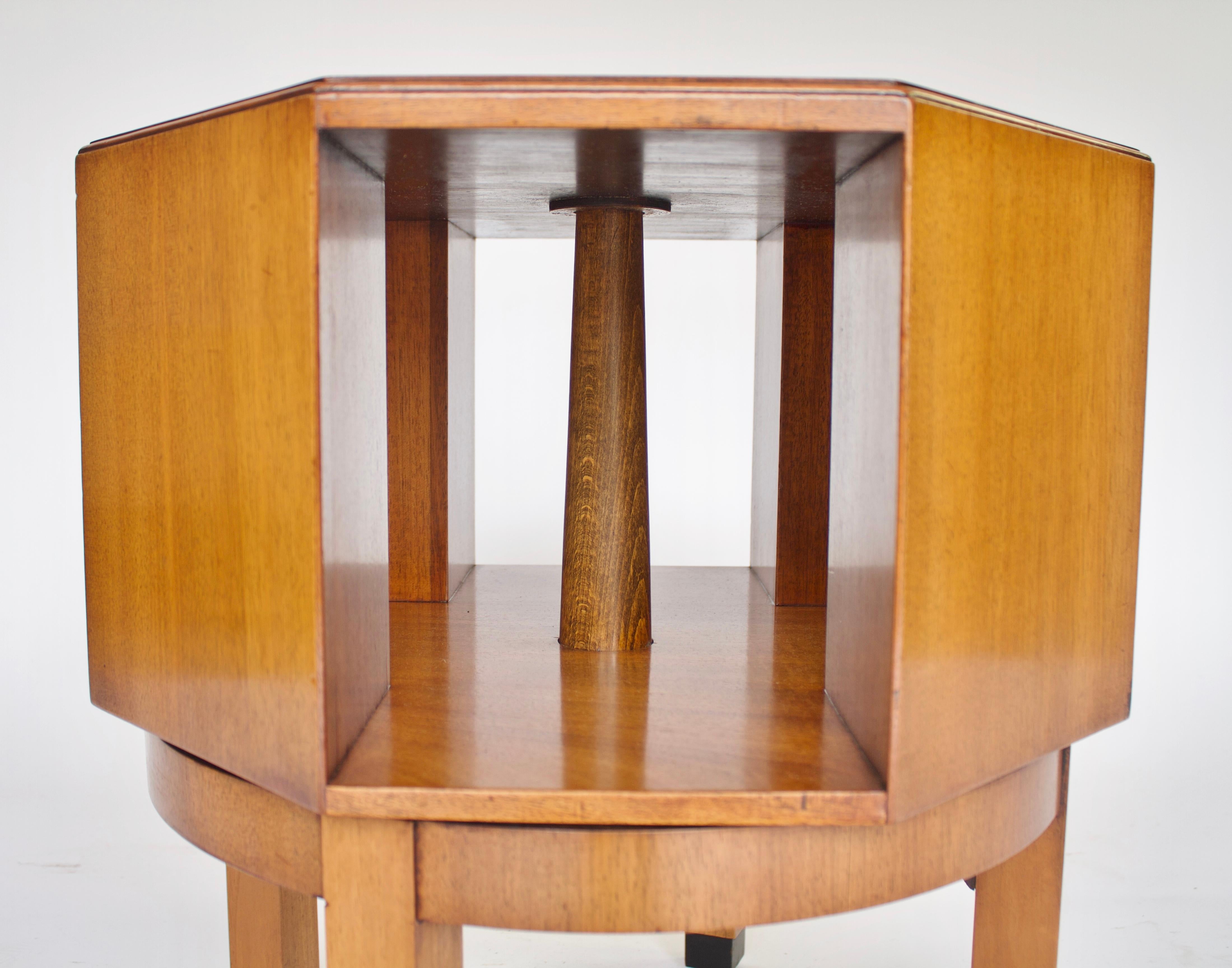 Art Deco Walnut Revolving Book Table circa 1920s
Octagonal in shape
Walnut Quarter veneer on top, 
4 open compartments to hold books, 
Revolving Action
Circular base with 4 Square shaped legs.
Inset black feet
Good Quality Table
Recently Polished